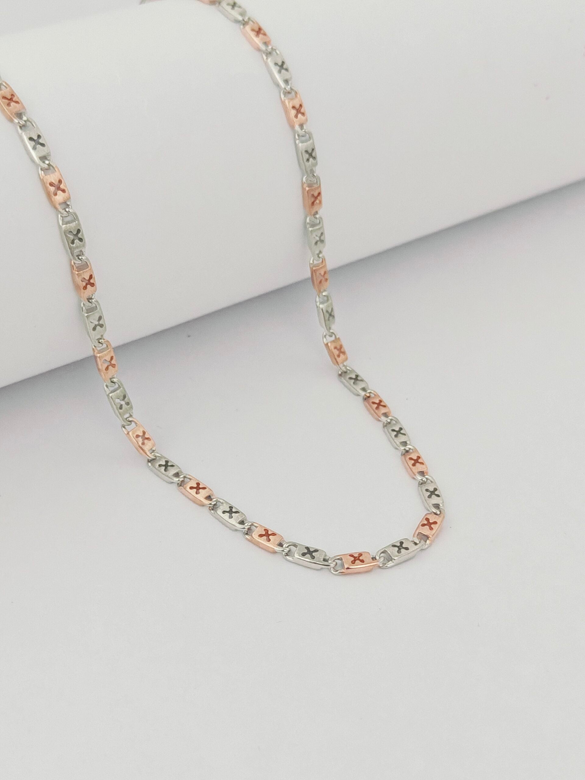 Tri-color diamond chain necklace on a light gray background