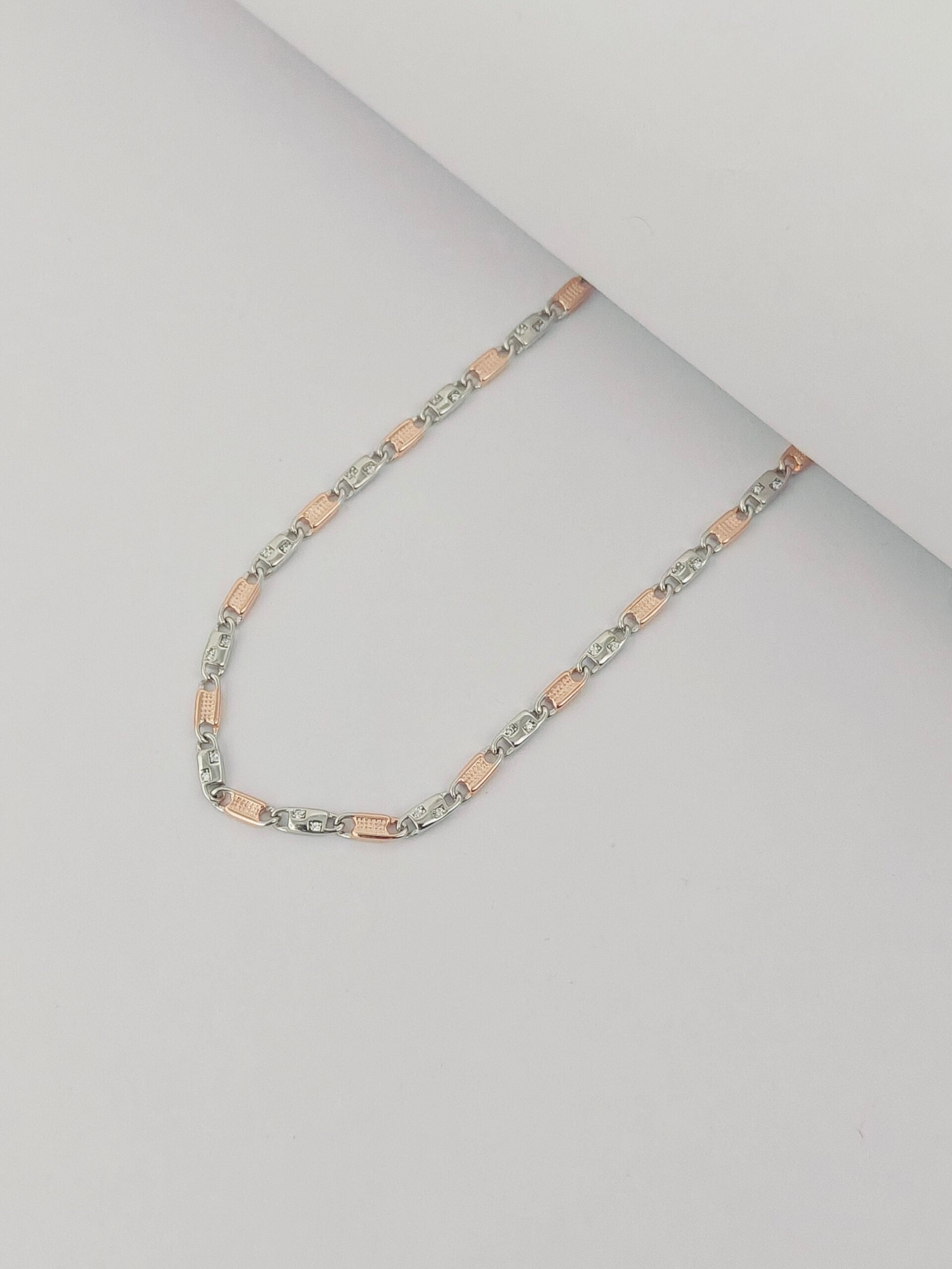 Two-tone chain necklace on a light gray background