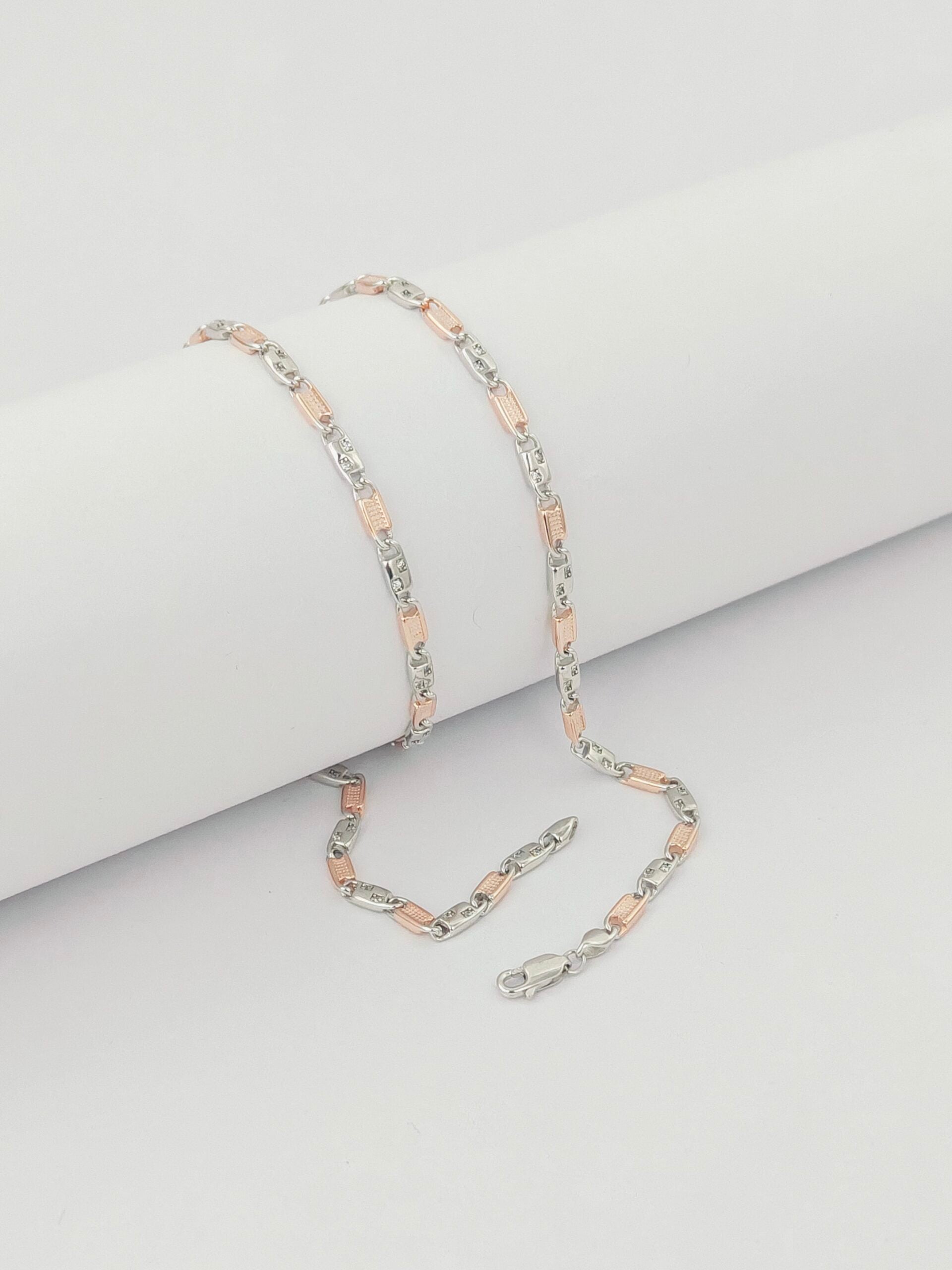 Necklace with pink and silver links on a light gray background