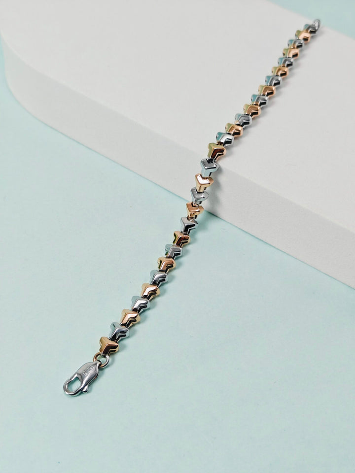 Bracelet with star-shaped links on a light blue and beige background