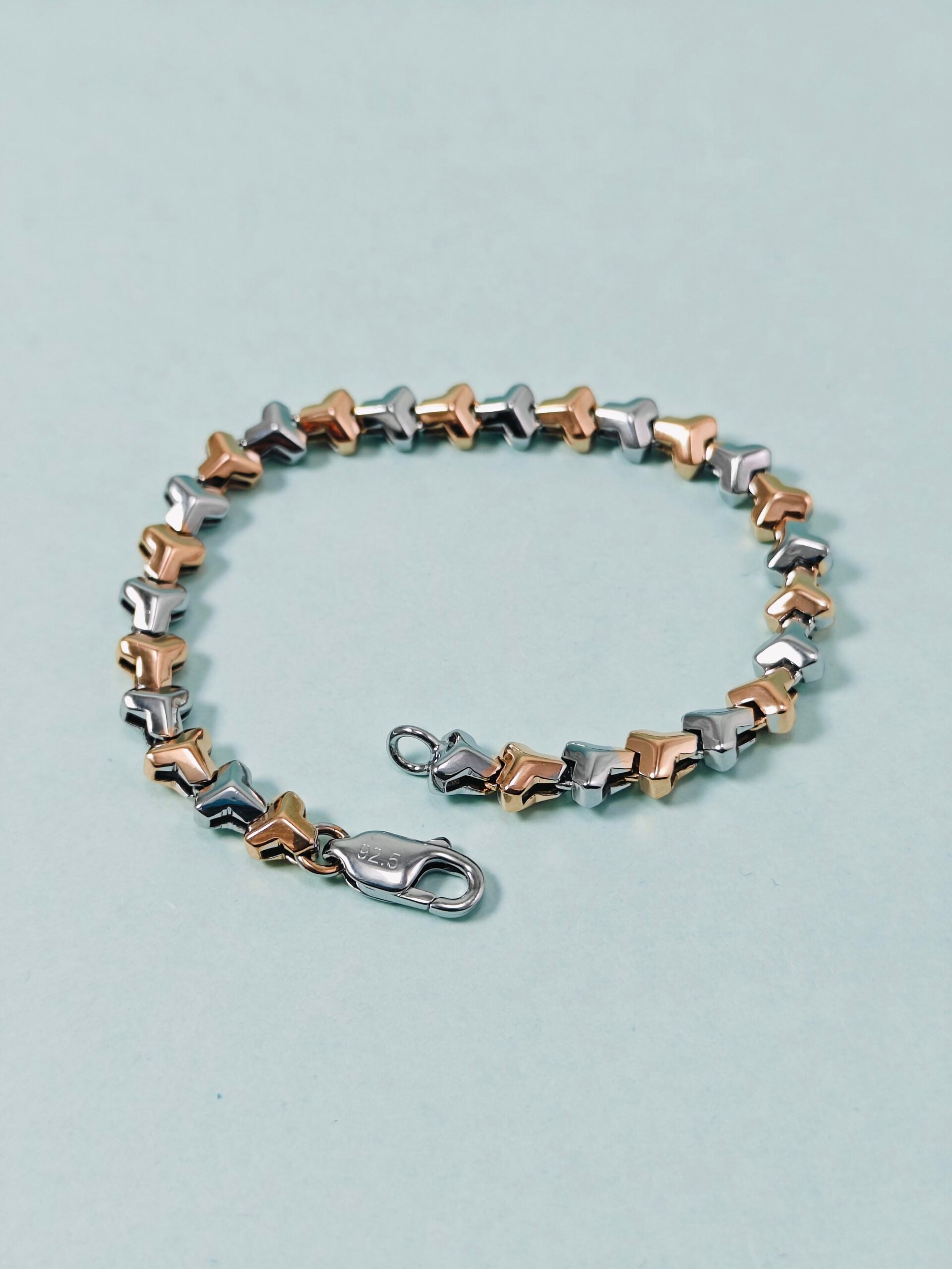 Bracelet with star-shaped links on a light blue background