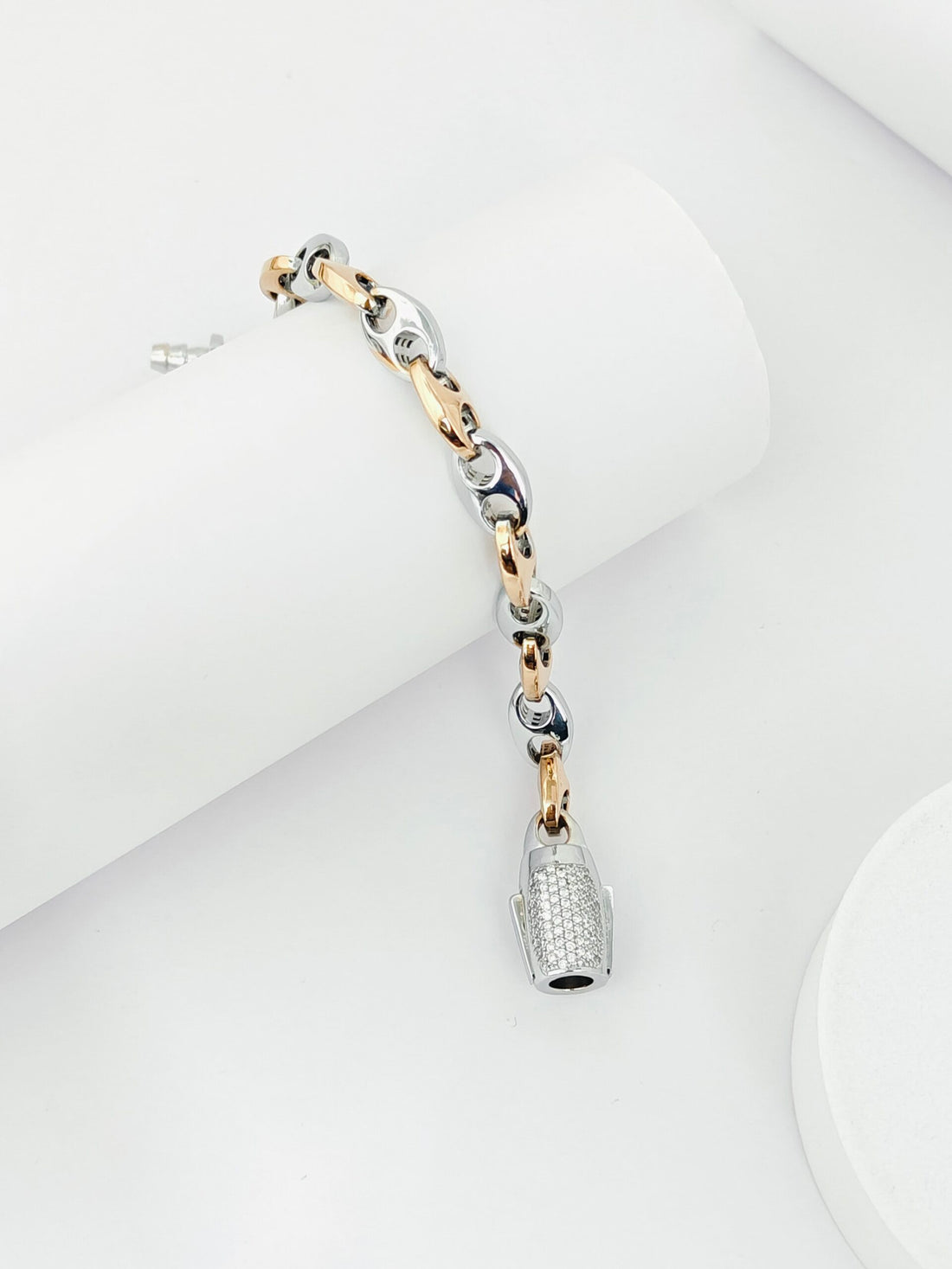Three-tone bracelet with a bottle charm on a white background