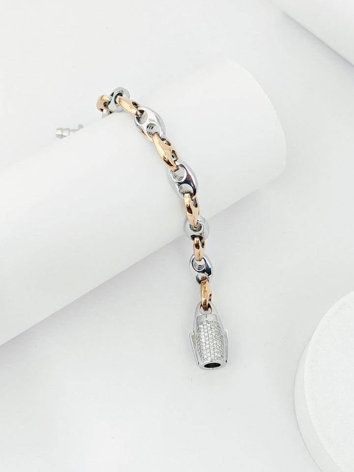 Three-tone bracelet with a bottle charm on a white background
