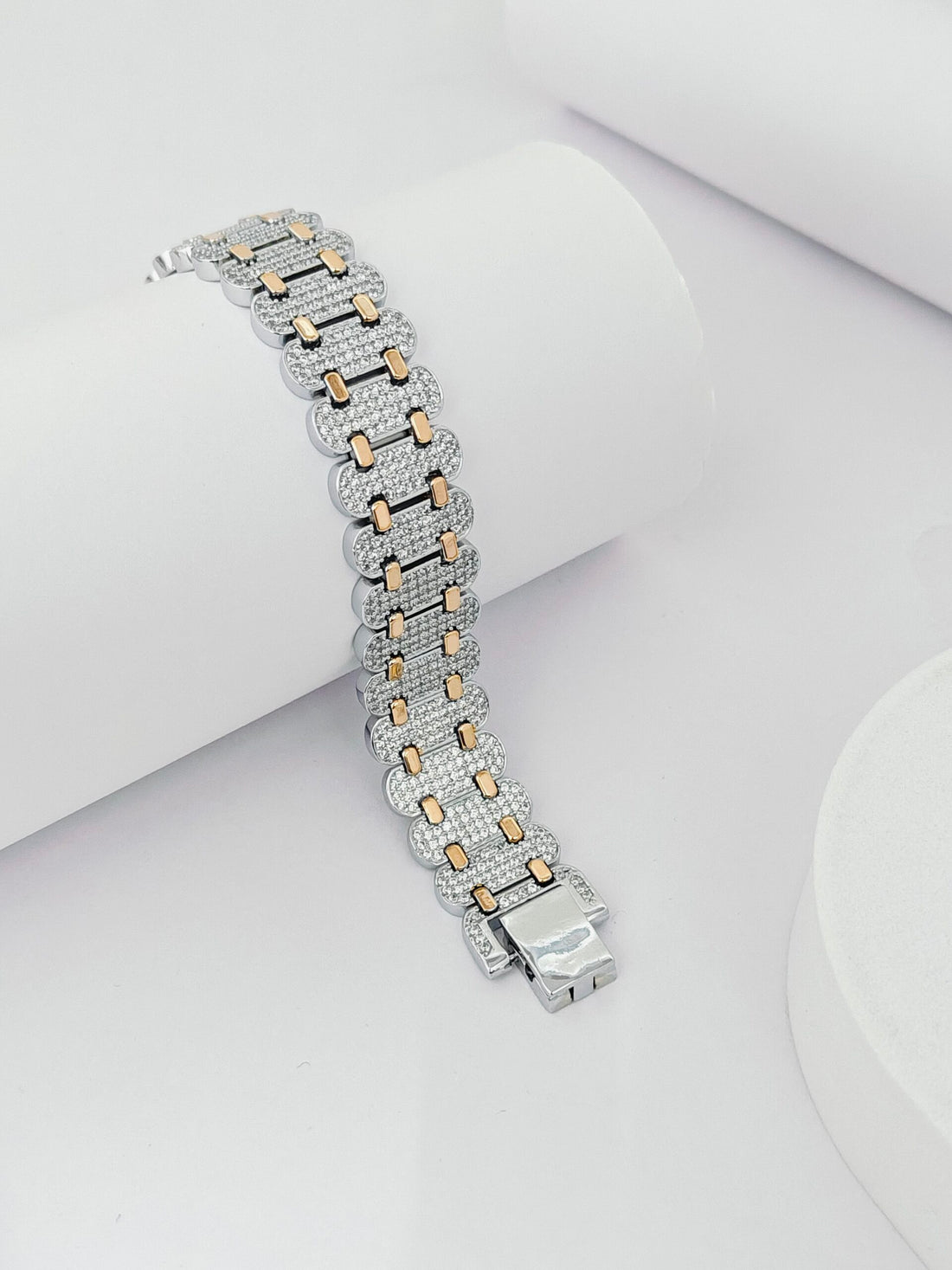 Silver and rose gold bracelet on a white surface