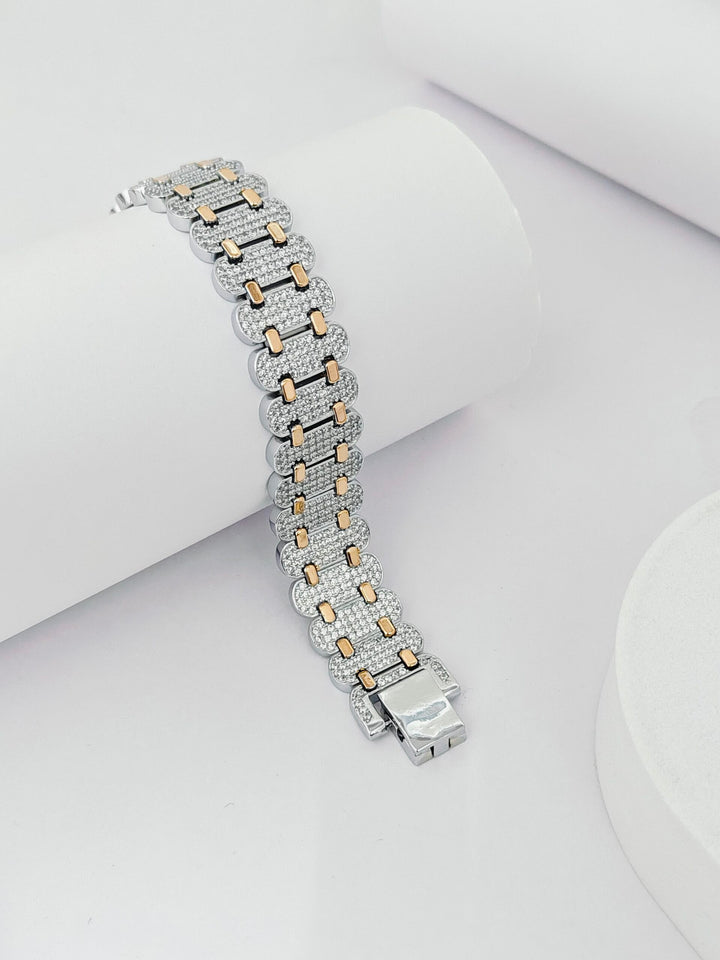 Silver and rose gold bracelet on a white surface