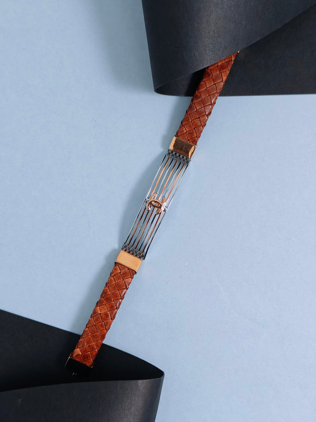 Fork with brown woven handle on a light blue background