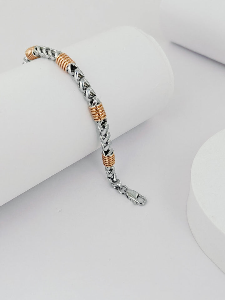 Bracelet with braided design and rose gold accents on a white background