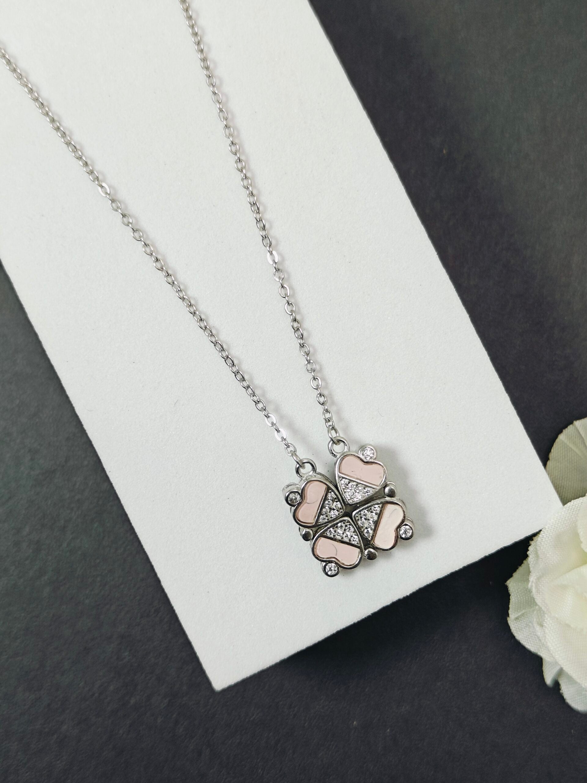 Necklace with a heart-shaped pendant on a white card with a black background