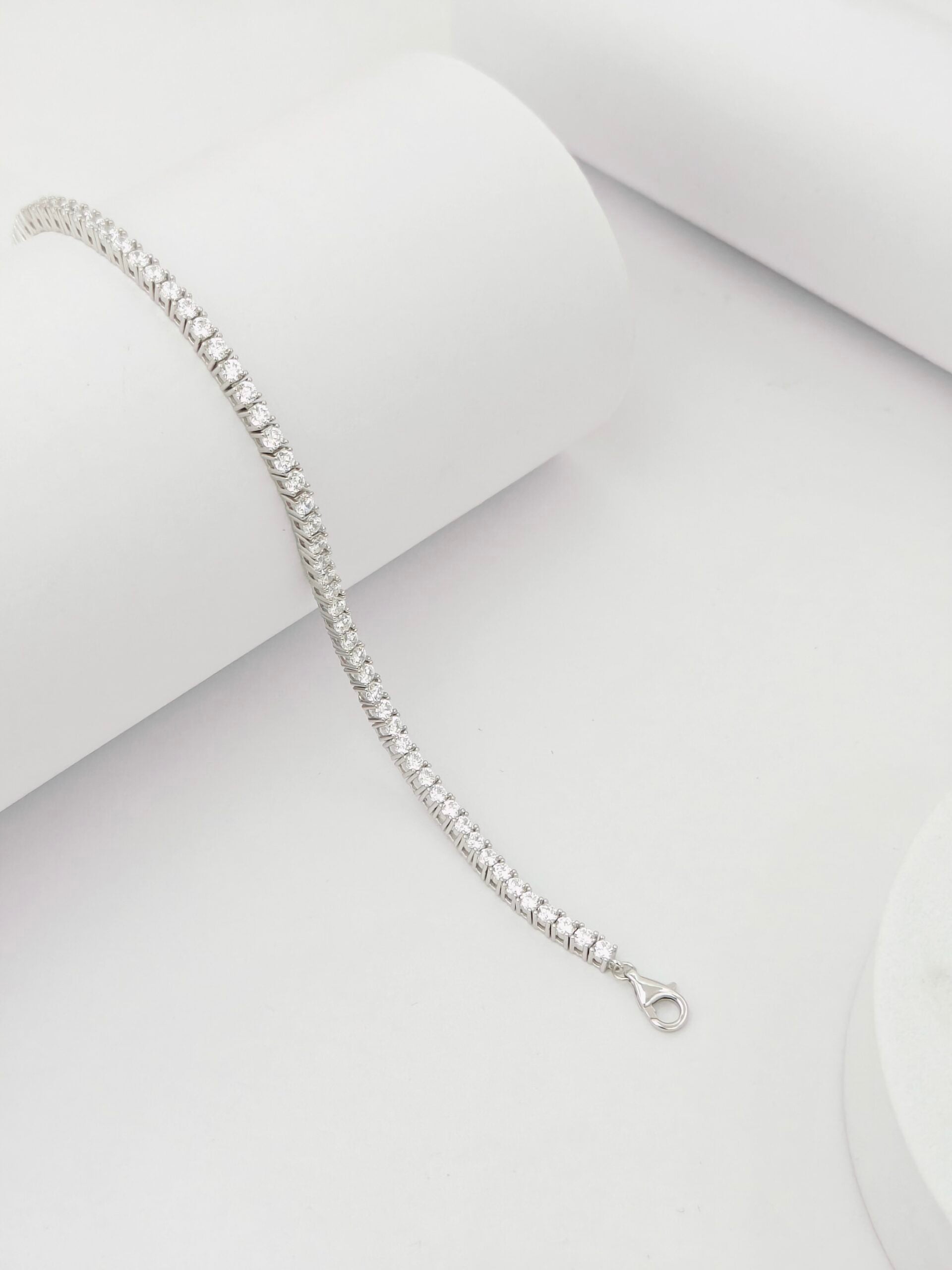 Silver bracelet on a light gray background