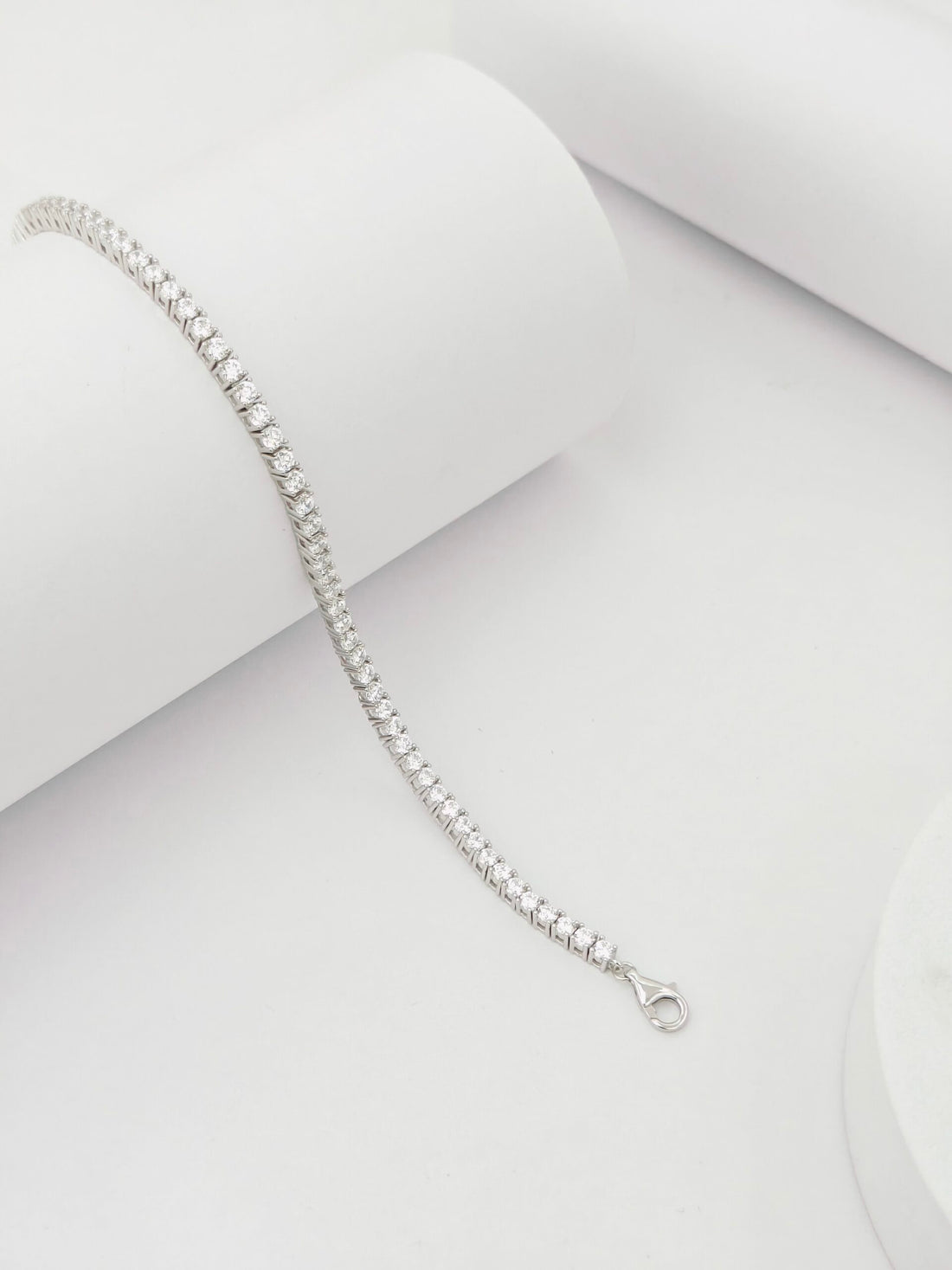 Silver bracelet on a light gray background