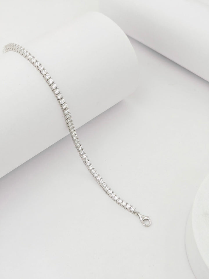 Silver bracelet on a light gray background