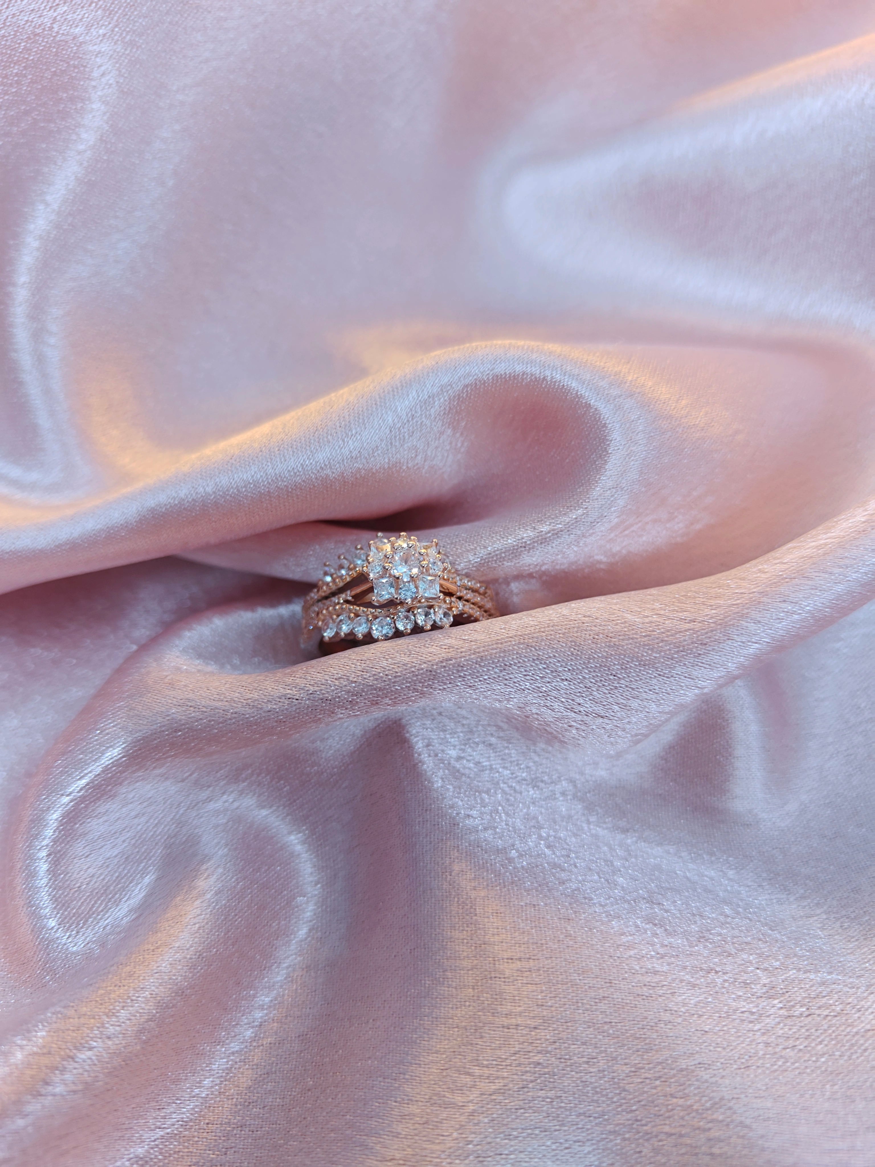 Diamond ring on a pink fabric background