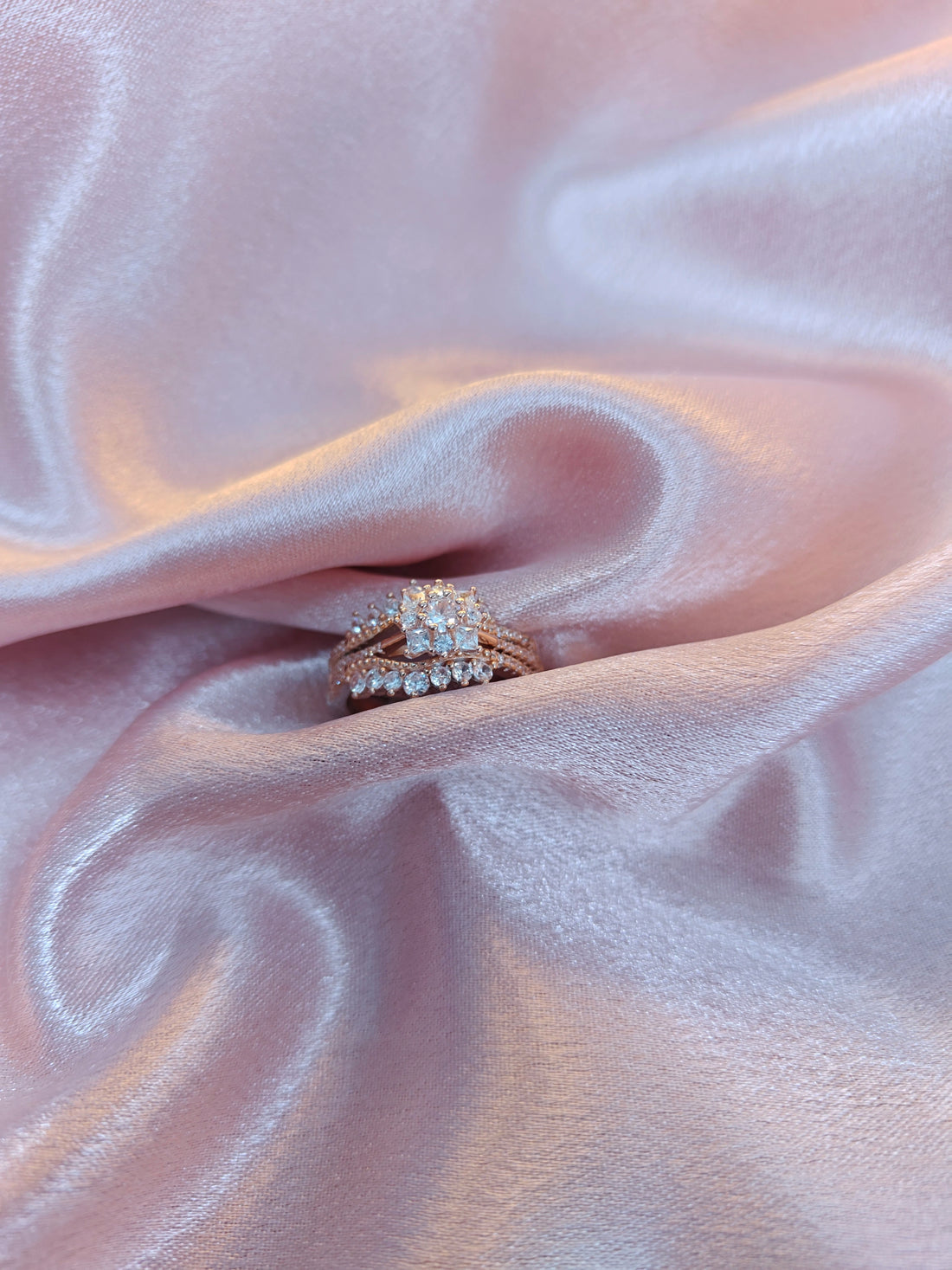 Diamond ring on a pink fabric background
