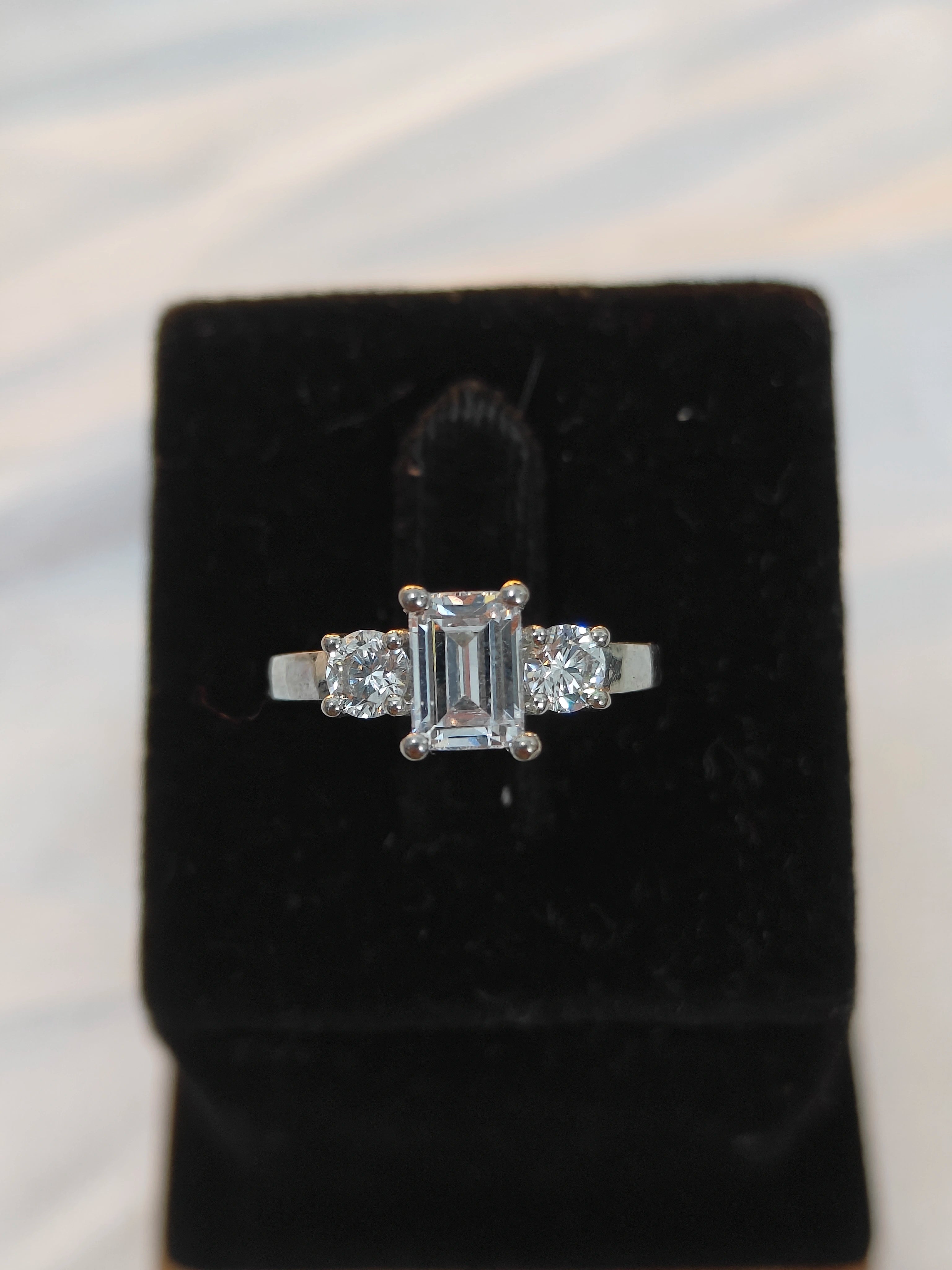 Diamond ring on a black velvet cushion with a blurred background