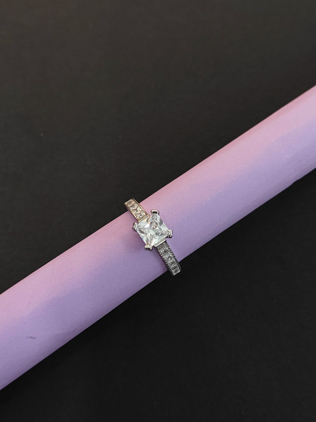 Diamond ring on a pink and black background