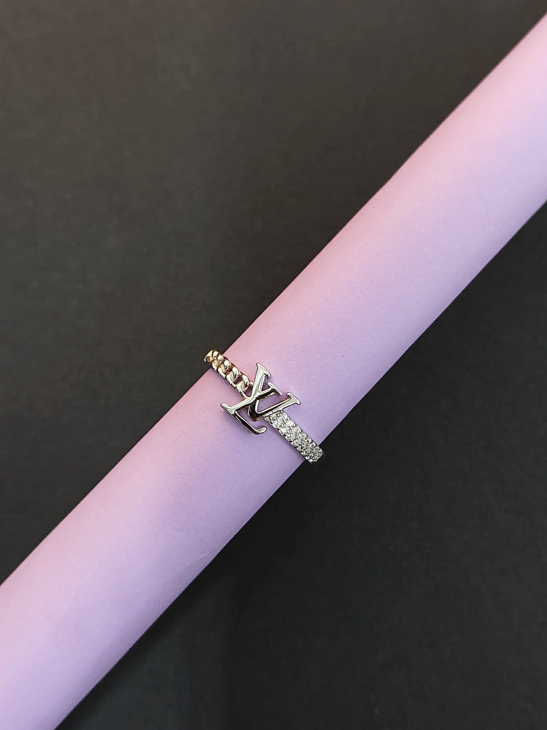 Two rings on a pink and black background