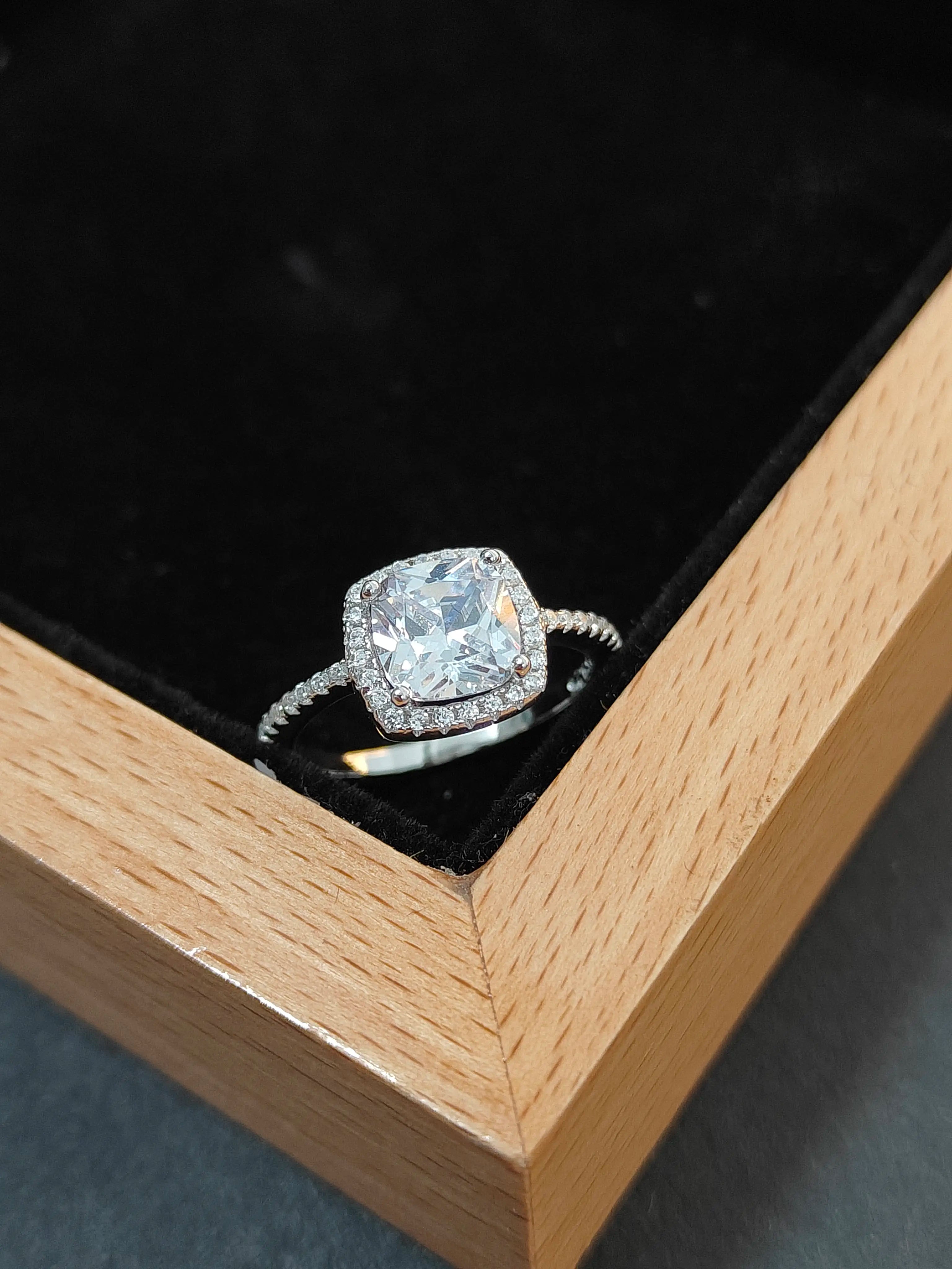 Diamond ring in a wooden box with a black interior
