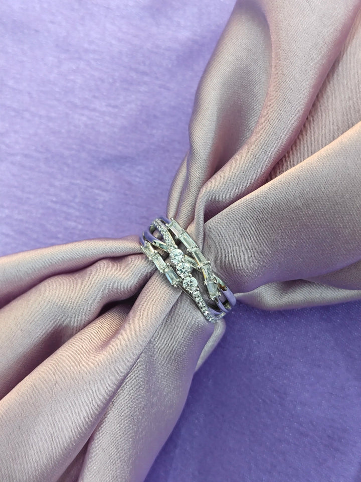 Silver ring on a pink fabric background