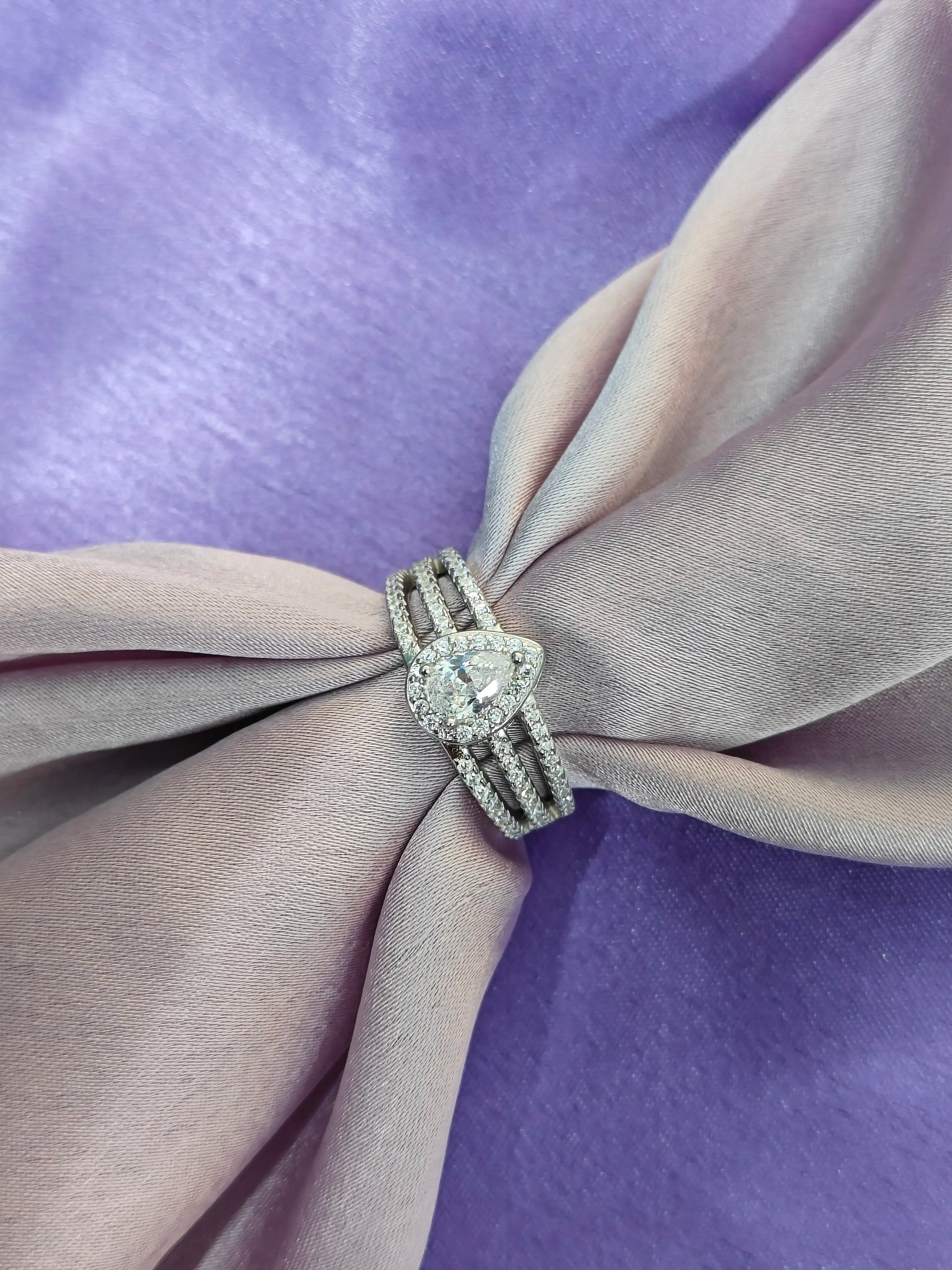 Diamond ring on a bow with a purple background