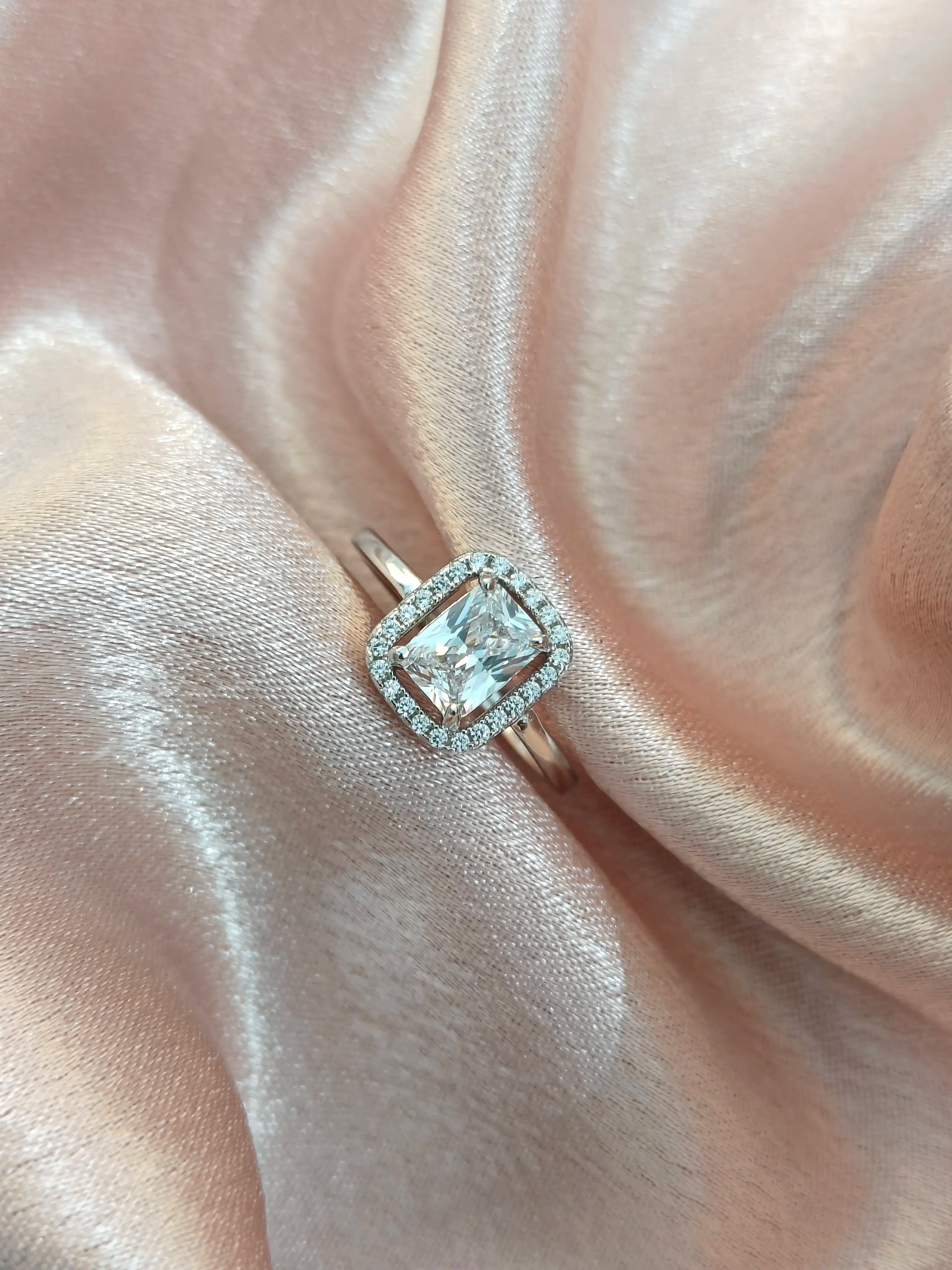 Diamond ring on a pink satin background