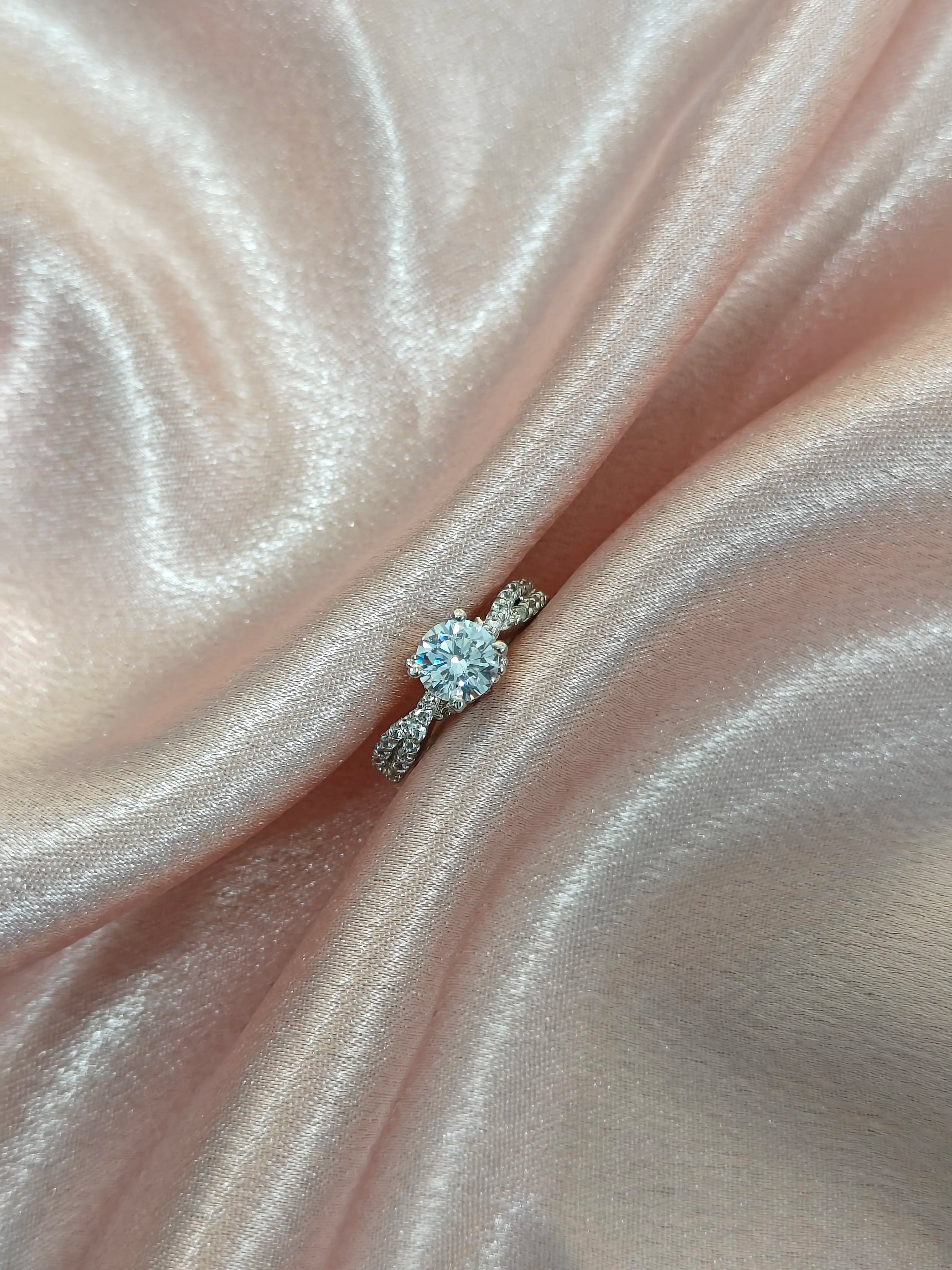 Diamond ring on a pink satin fabric