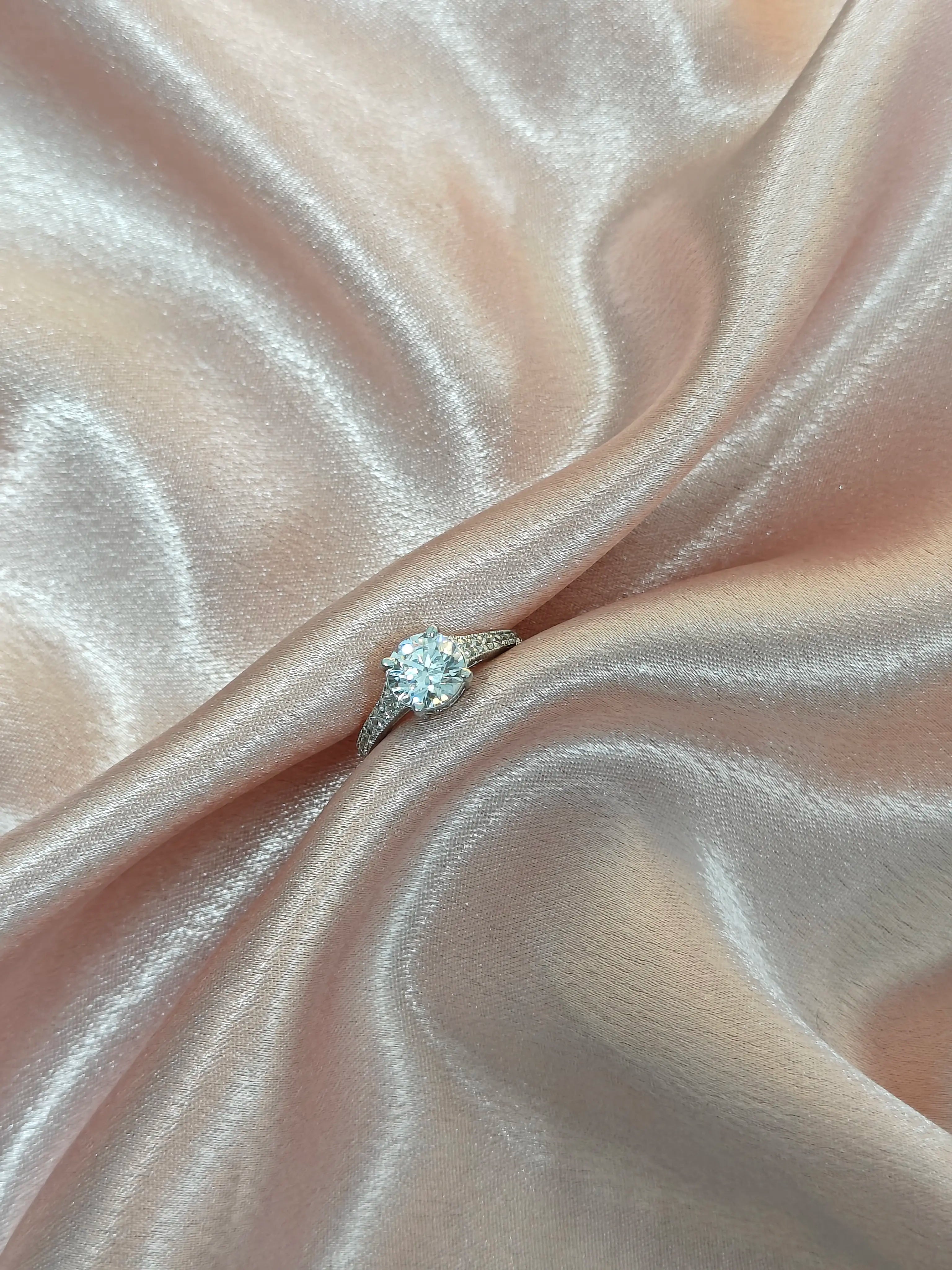 Diamond ring on a pink satin fabric