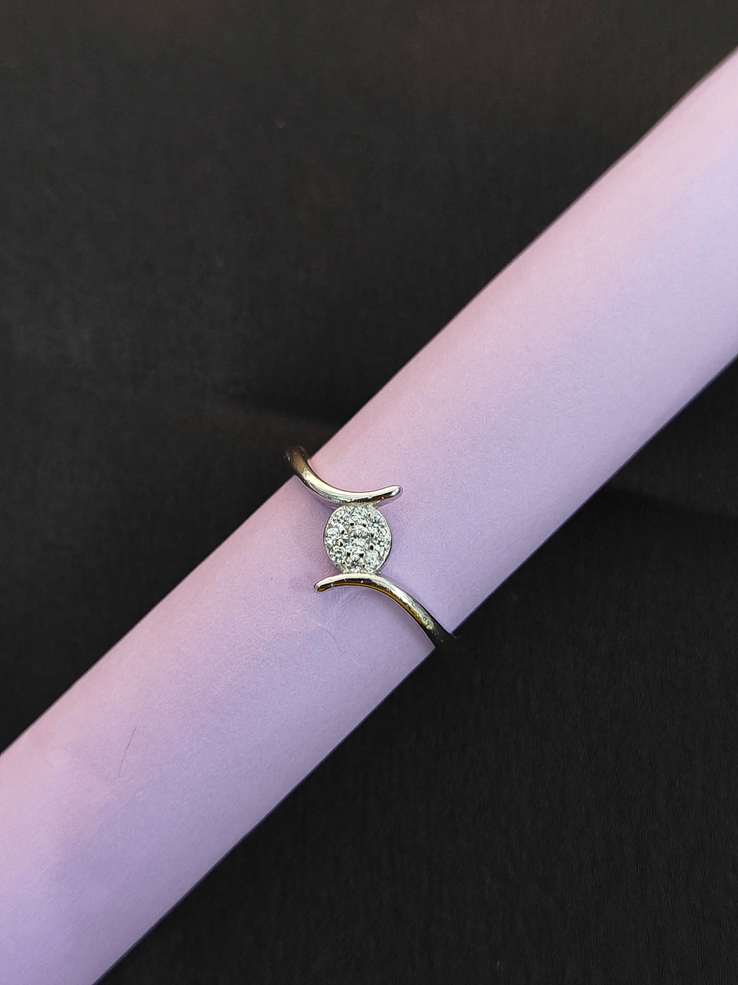 Gold ring with a green gemstone on a black background