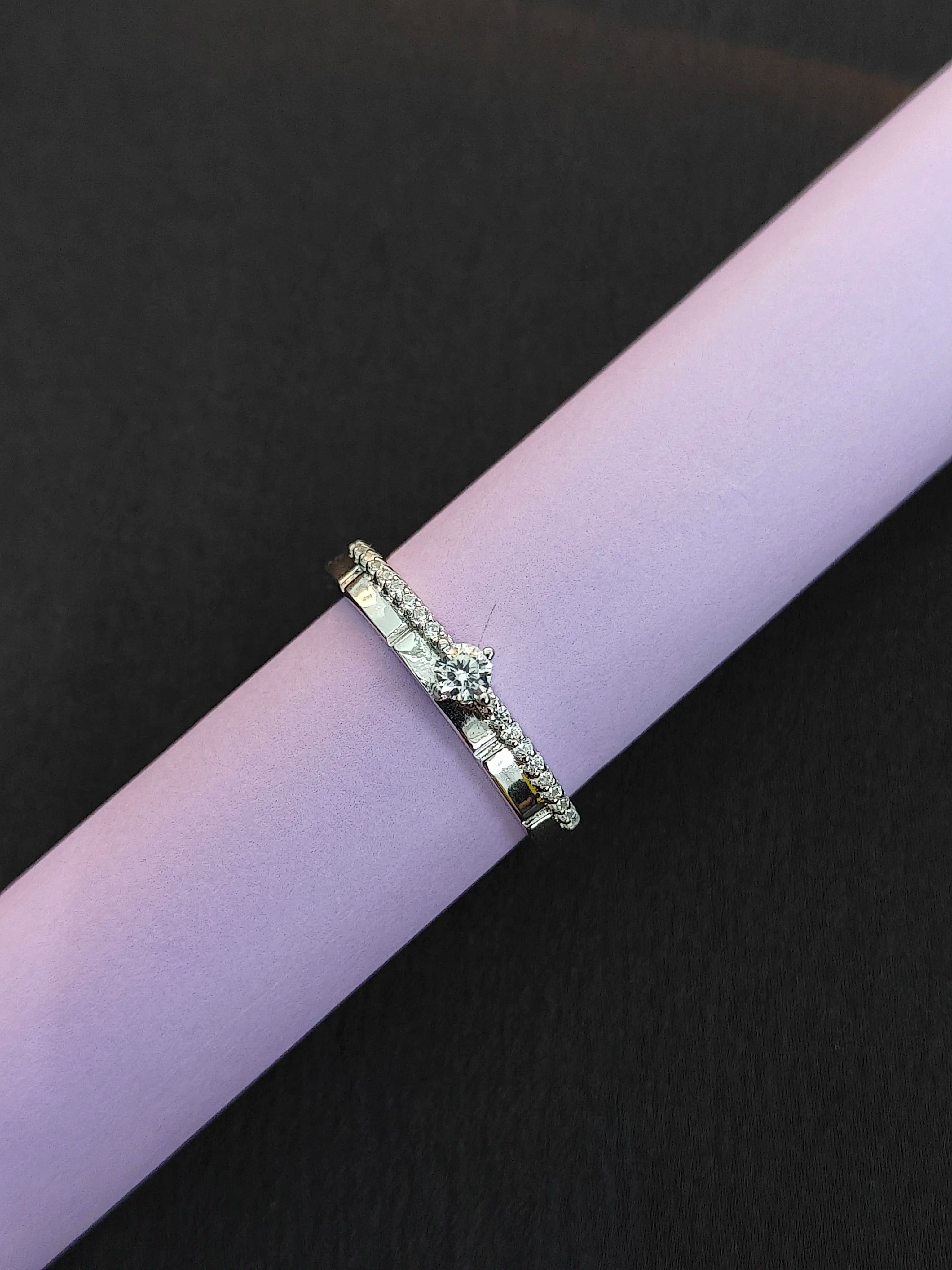 Gold ring with green gemstone on a black background