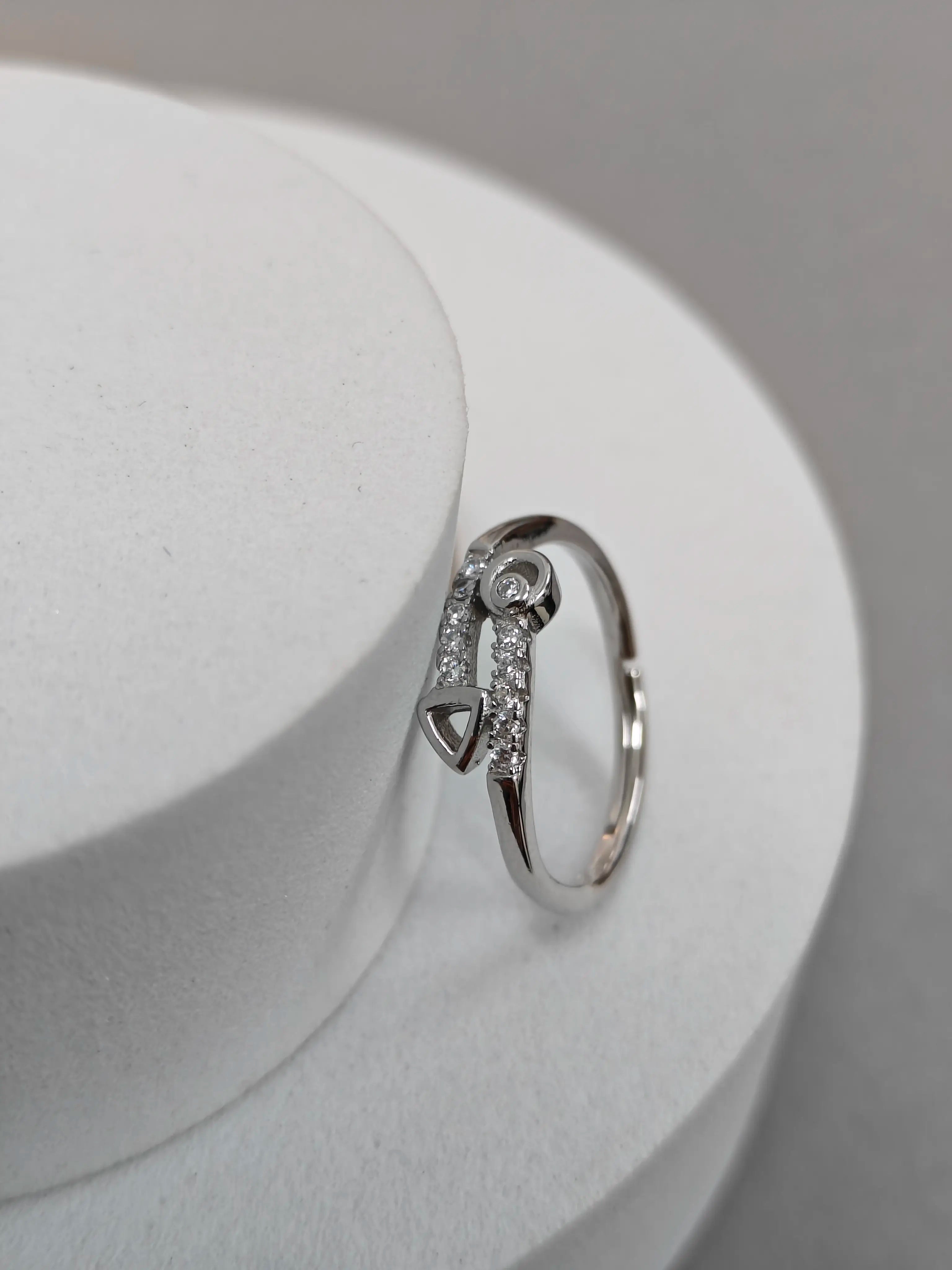 Silver ring with diamonds on a white surface