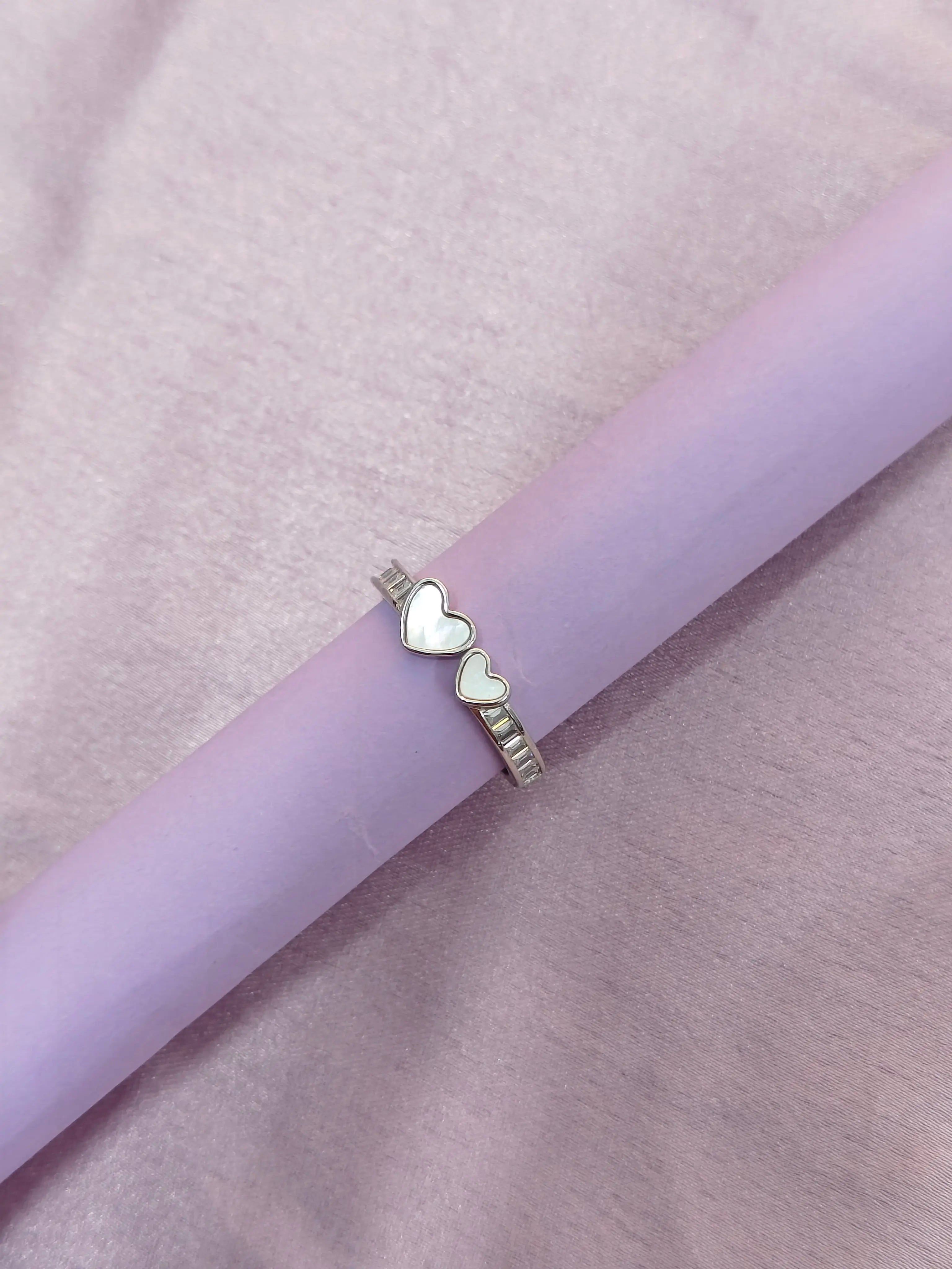 Purple pen with heart-shaped design on a light purple background