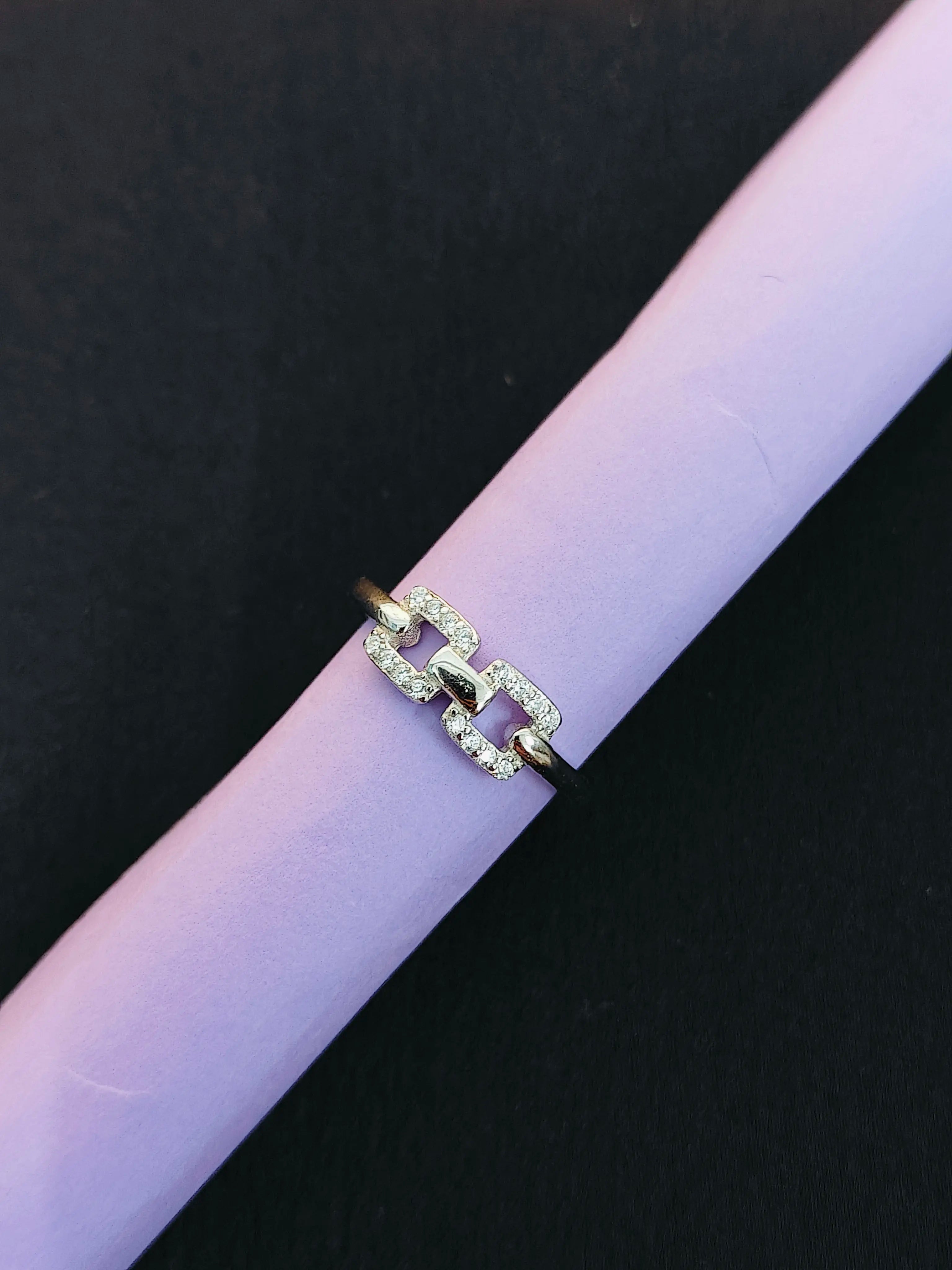 Silver chain ring on a black background