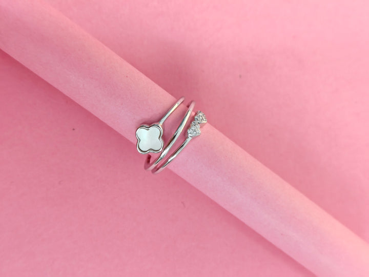 Two silver rings on a pink background