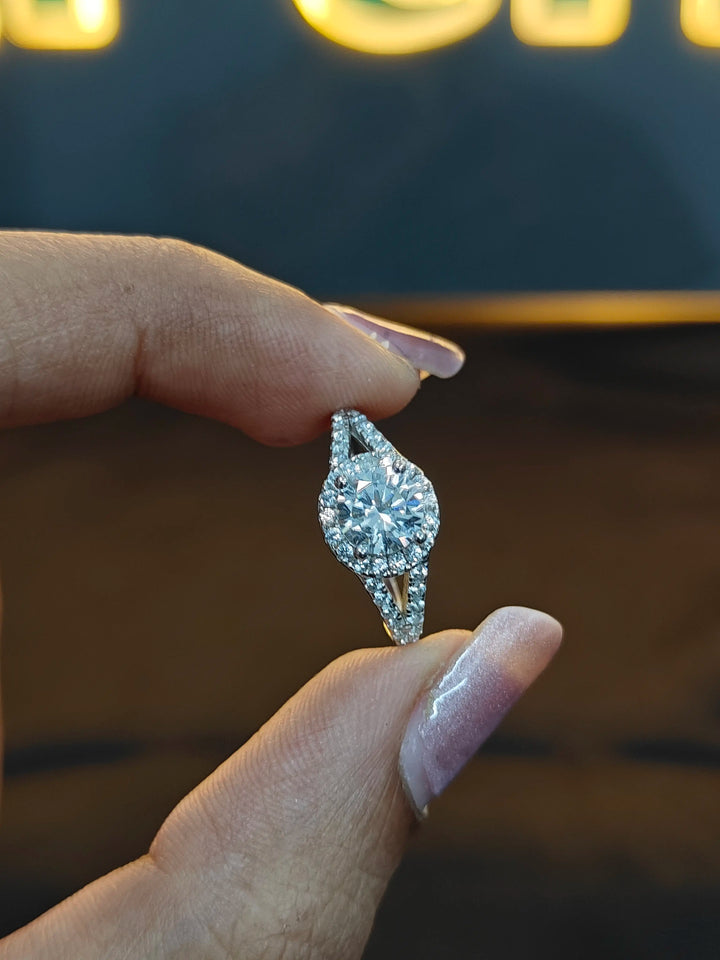 Diamond earring held between fingers against a blurred background