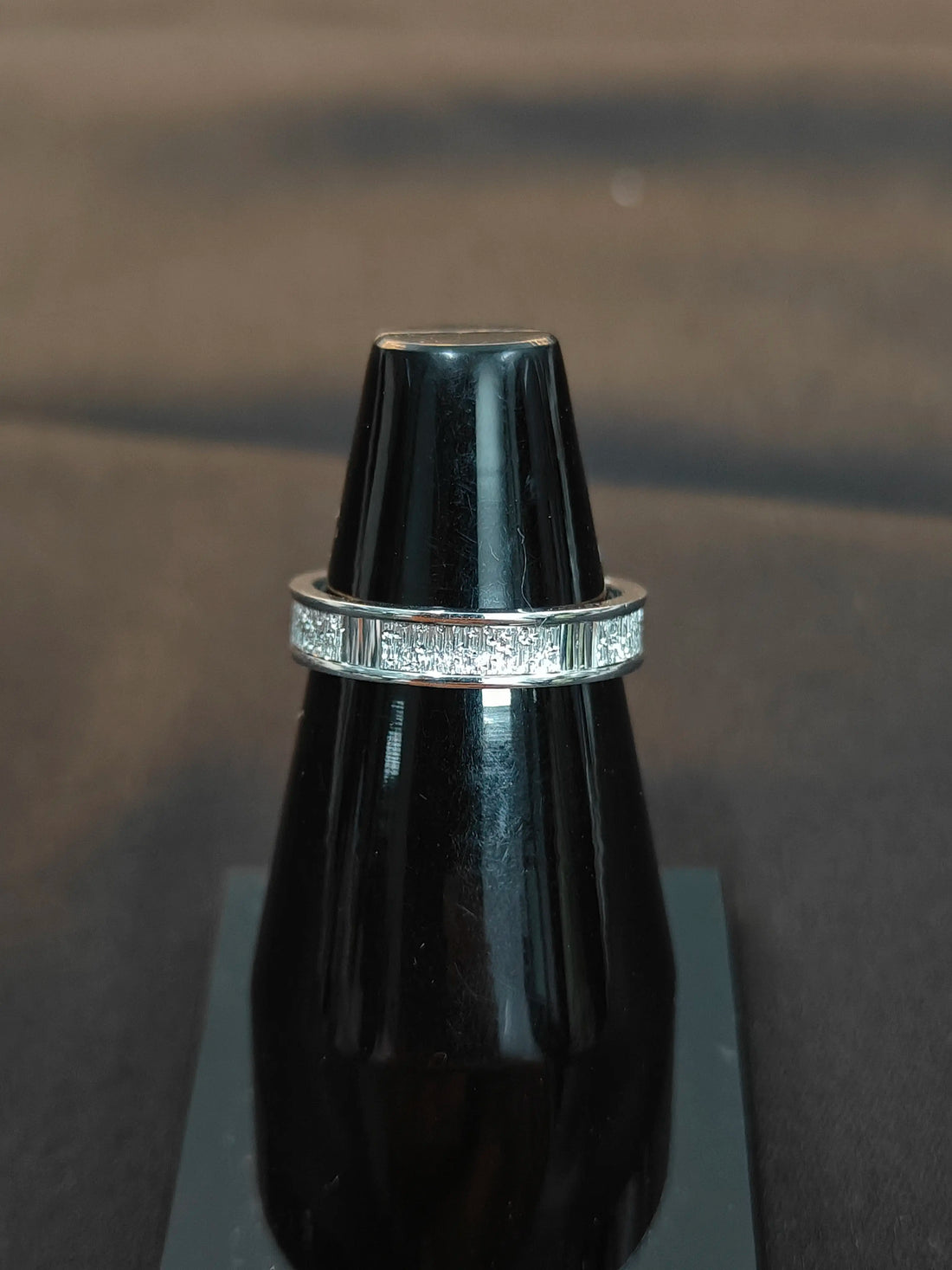 Silver ring with a black background