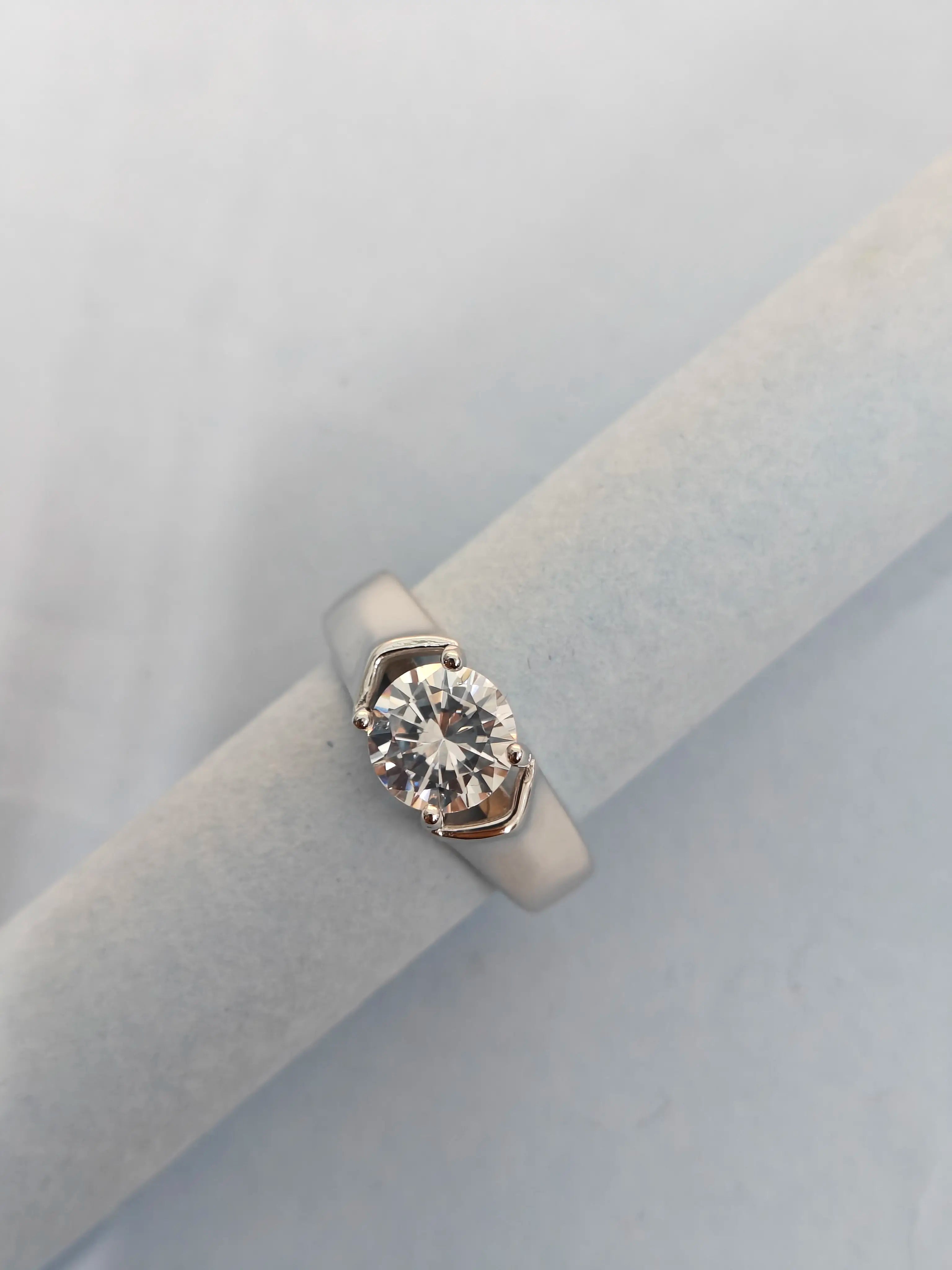 Diamond ring on a light gray cushion