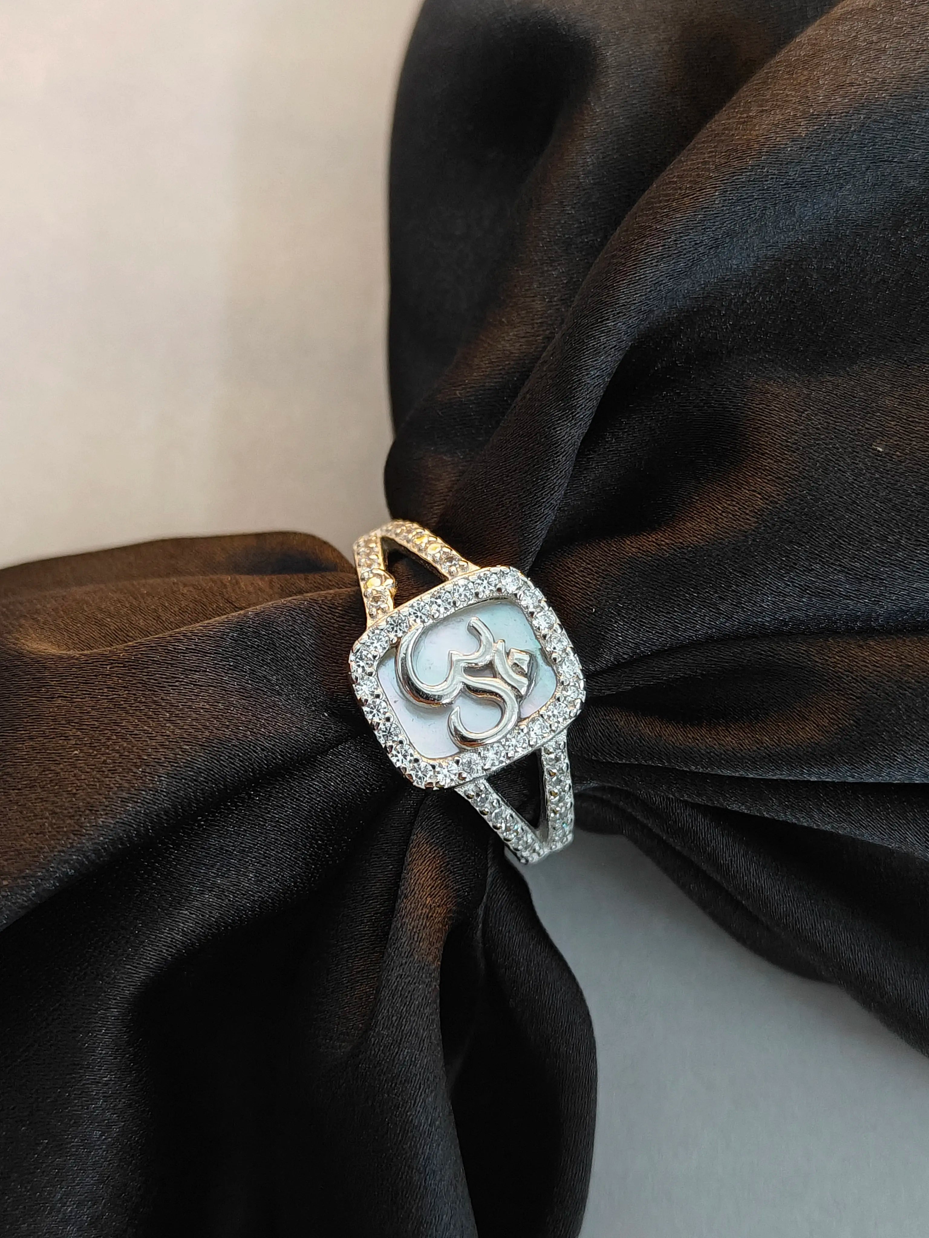 Elegant ring with a decorative design on a black fabric background