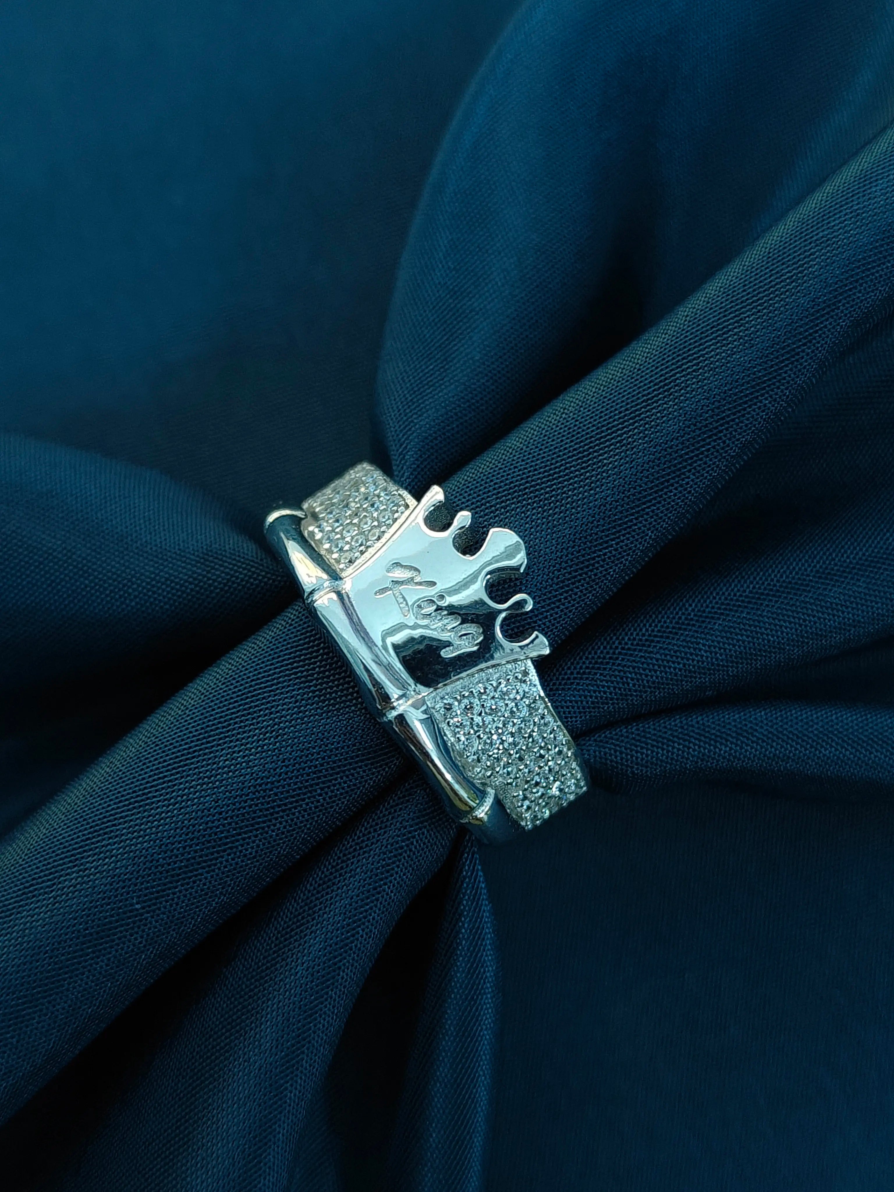 Silver clasp on a navy blue fabric