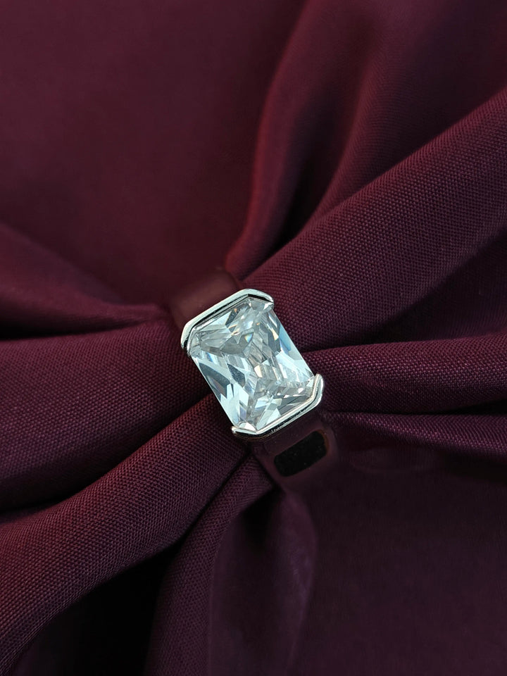 Clear gemstone on a burgundy fabric background