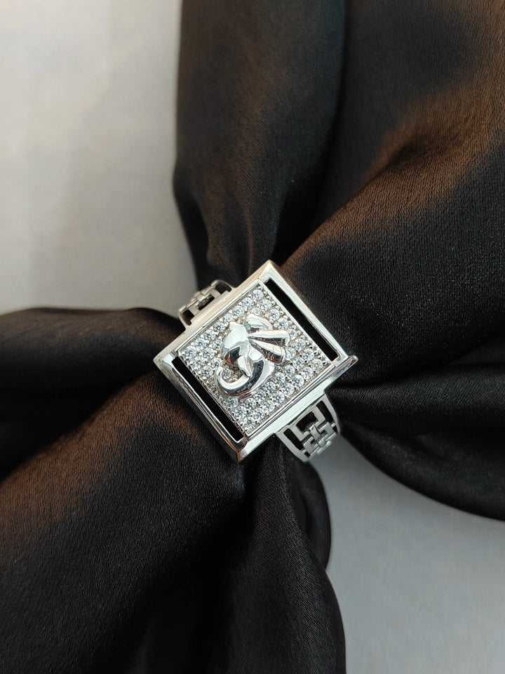 Silver bracelet with a diamond-encrusted clasp on black fabric
