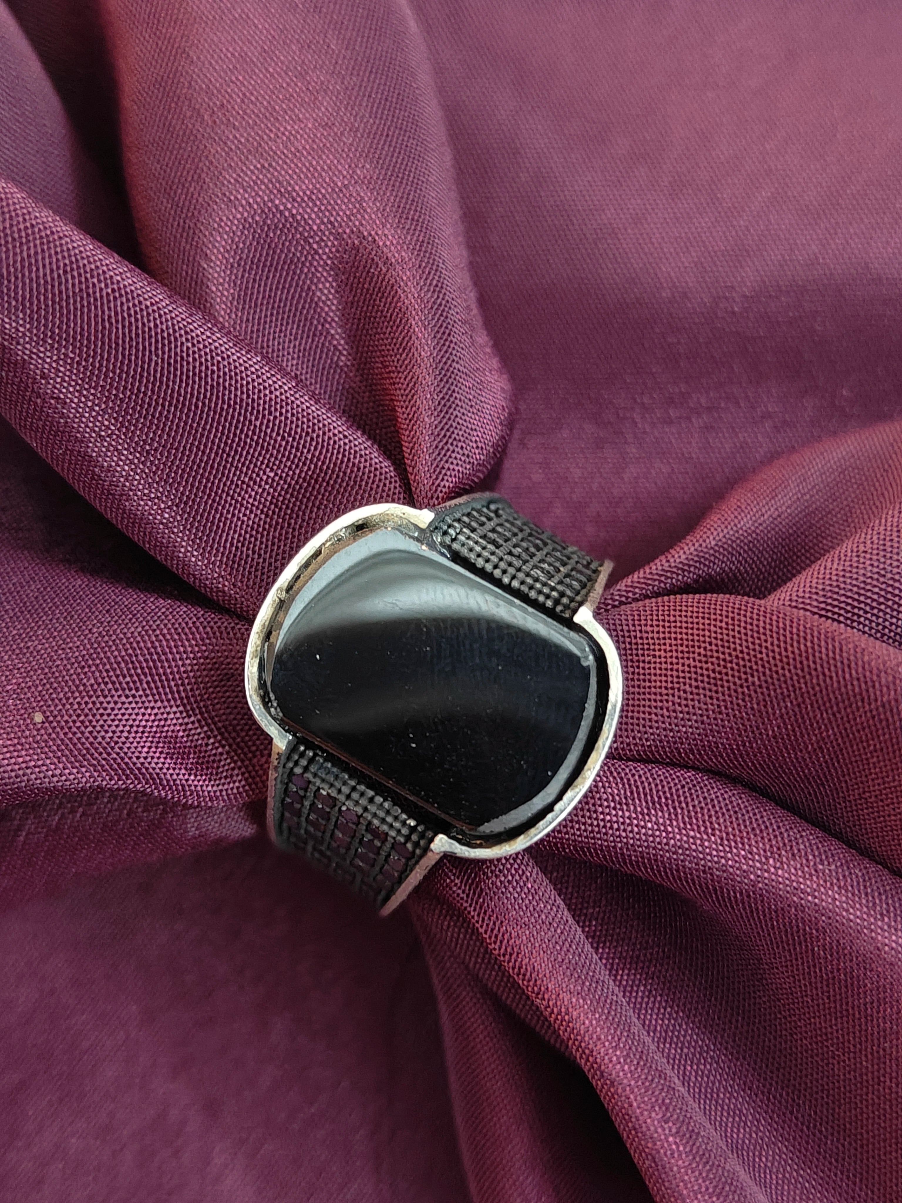 Black watch on a purple fabric background