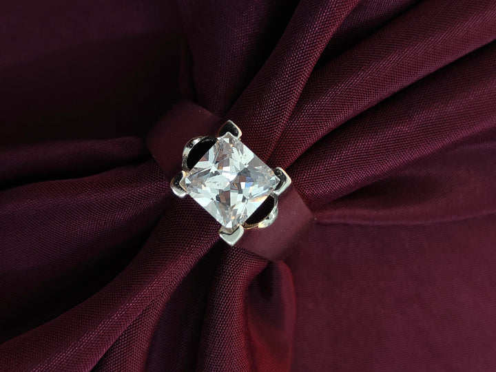 Diamond ring on a burgundy fabric background