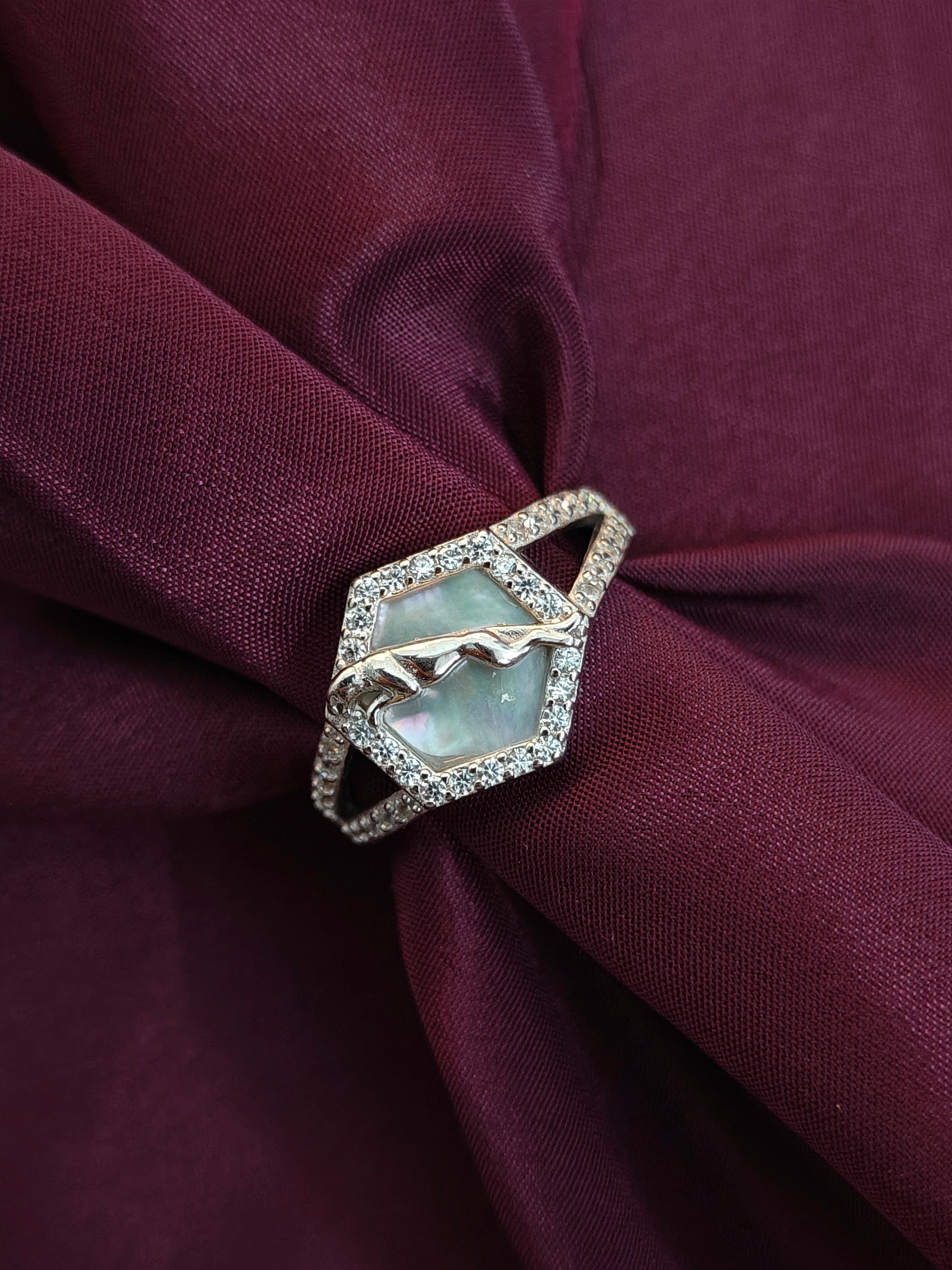 Elegant ring with a gemstone on burgundy fabric