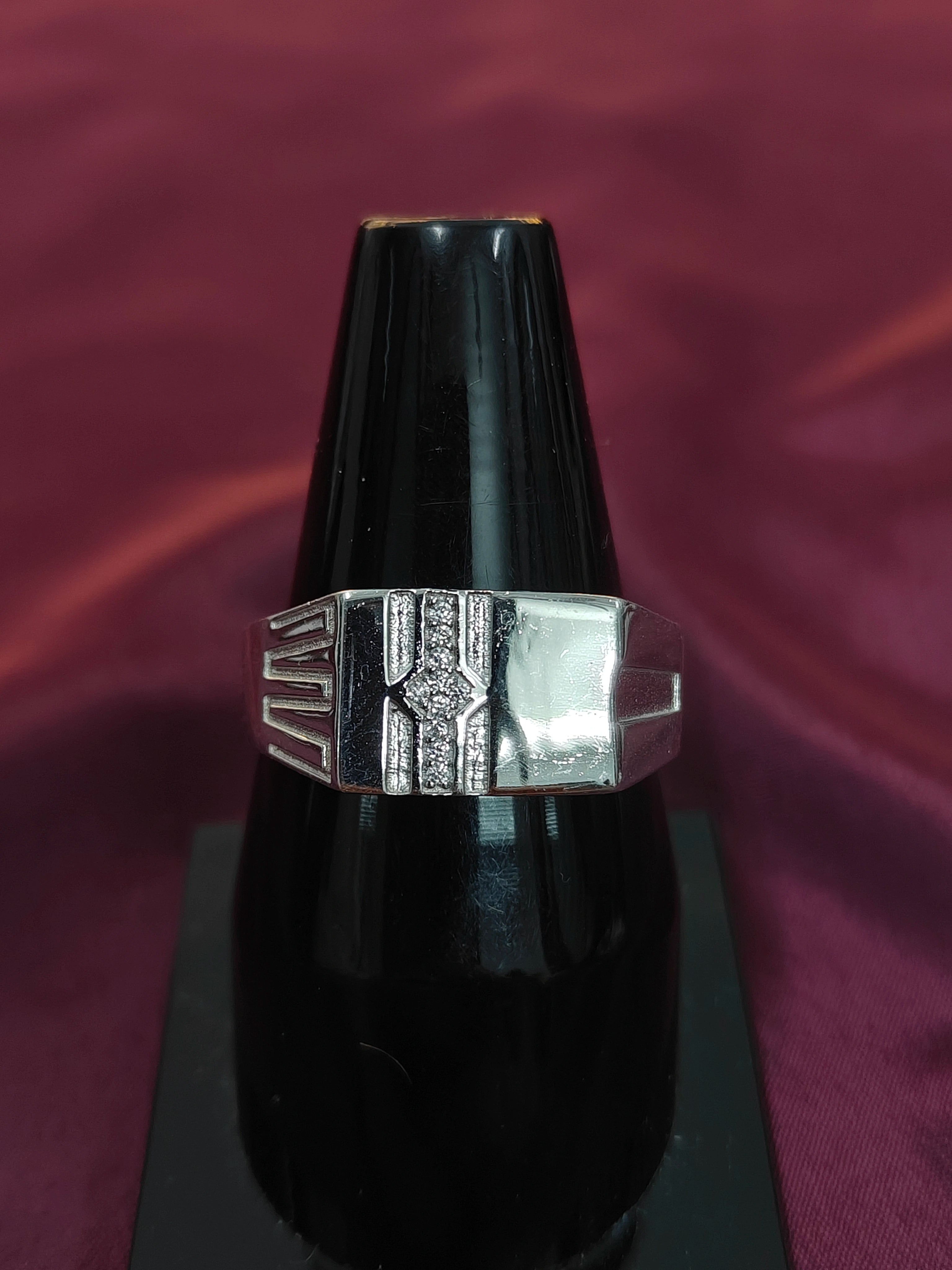 Silver ring with a black background