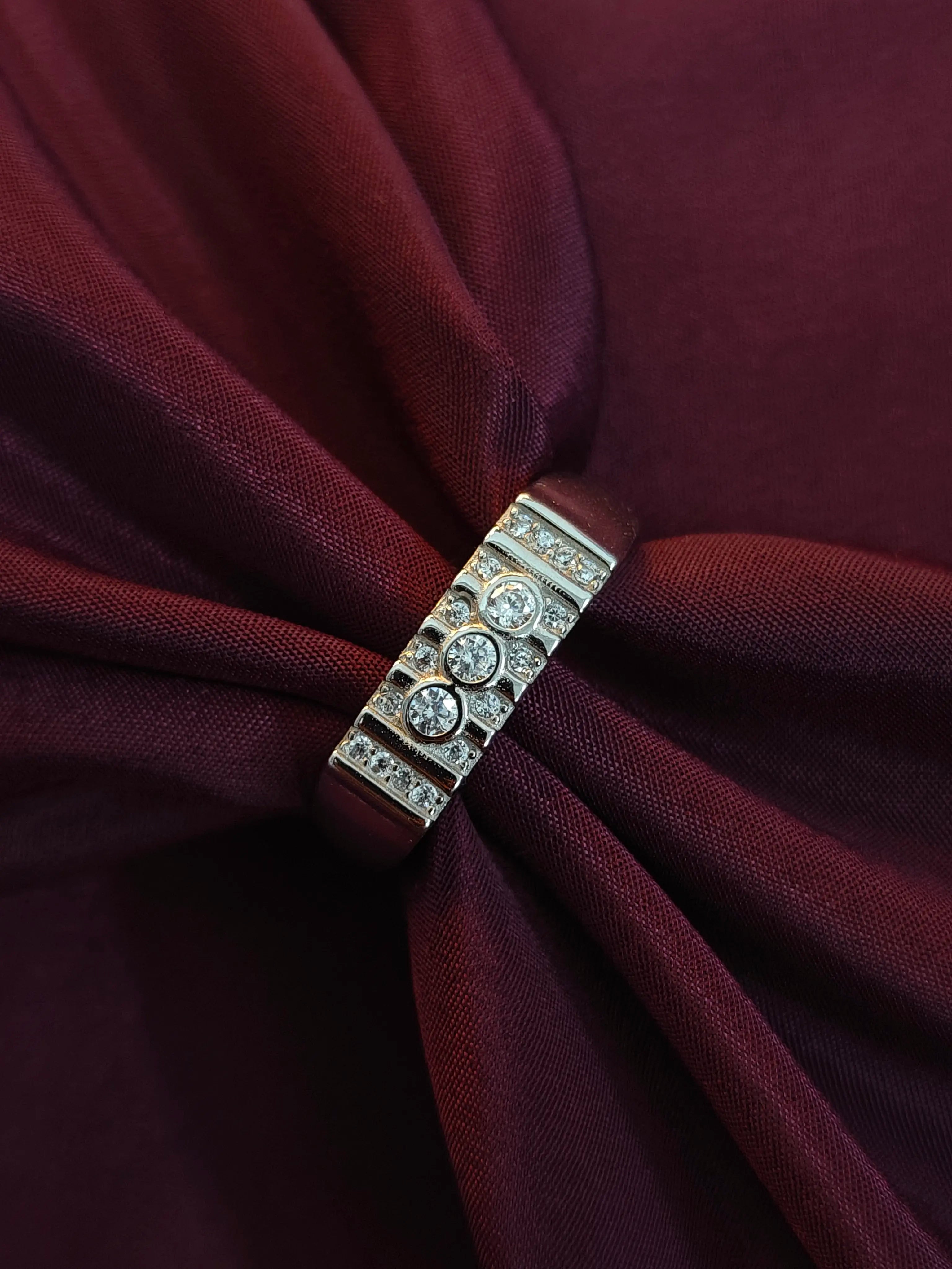 Close-up of a brooch on a burgundy fabric background