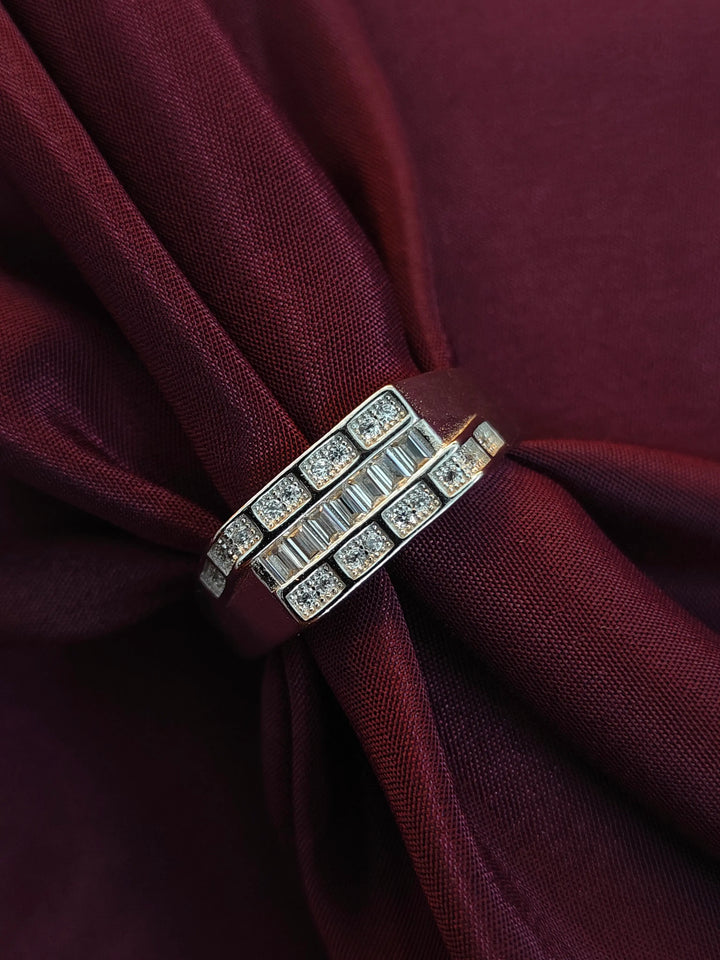 Two diamond rings on a burgundy fabric background