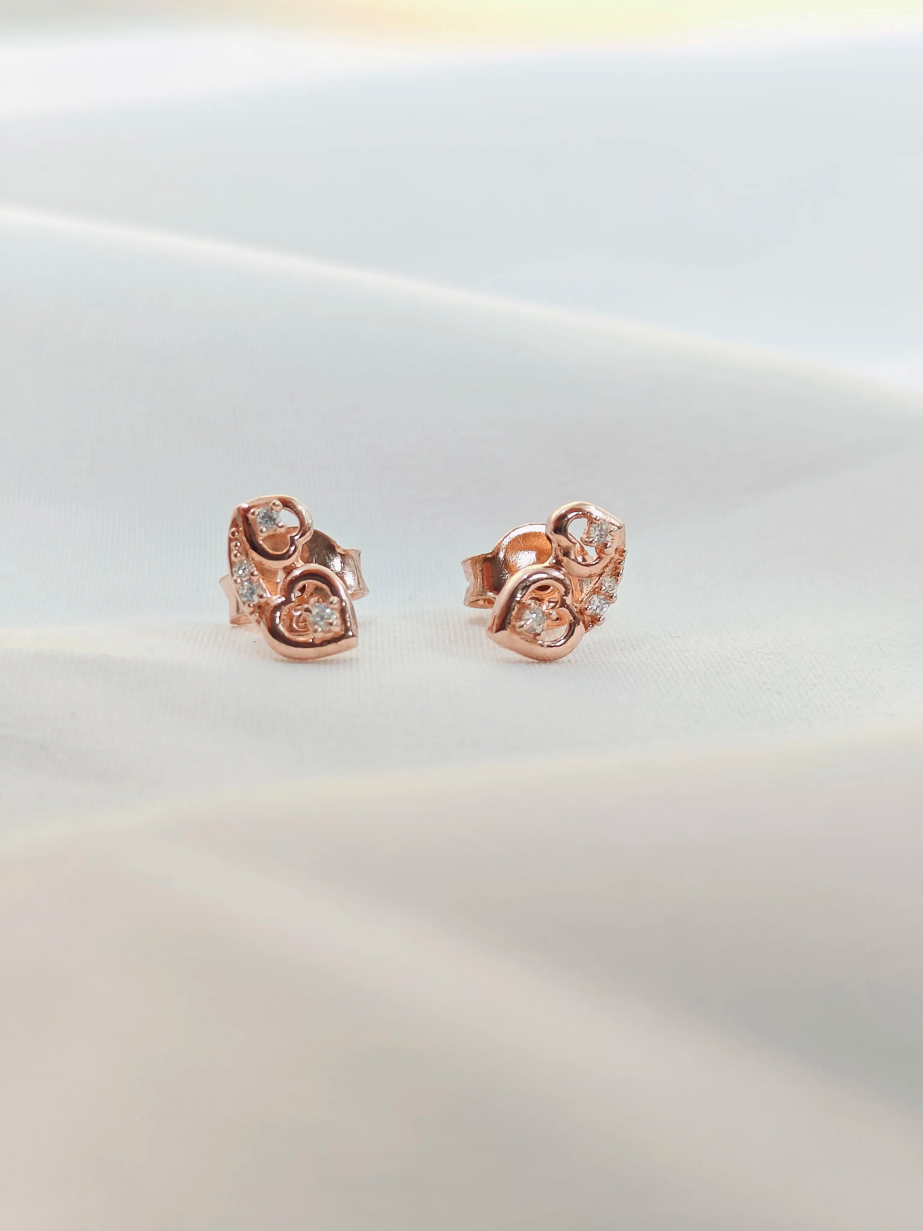 Rose gold earrings on a white background