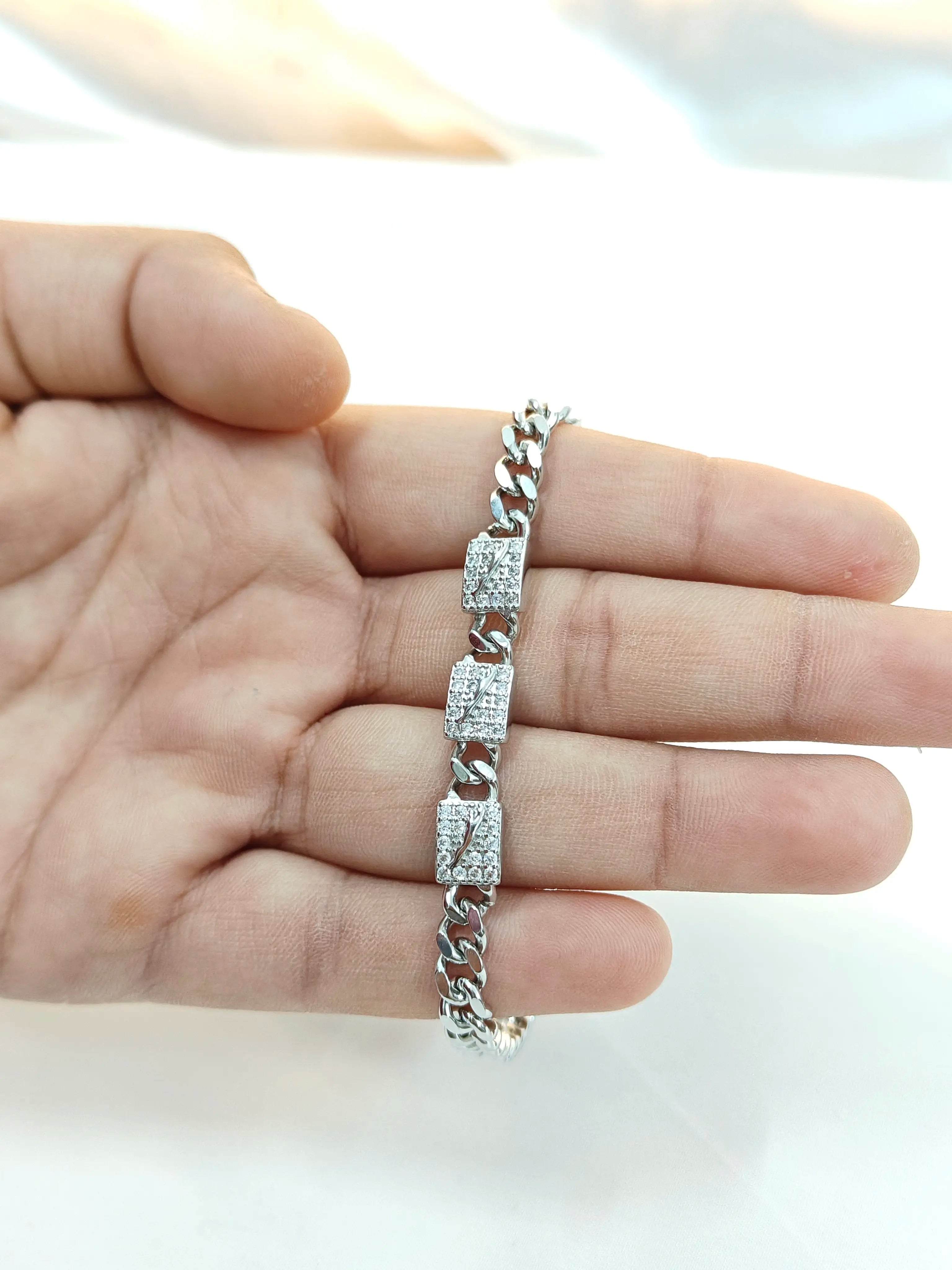 Silver bracelet on a hand with a blurred background