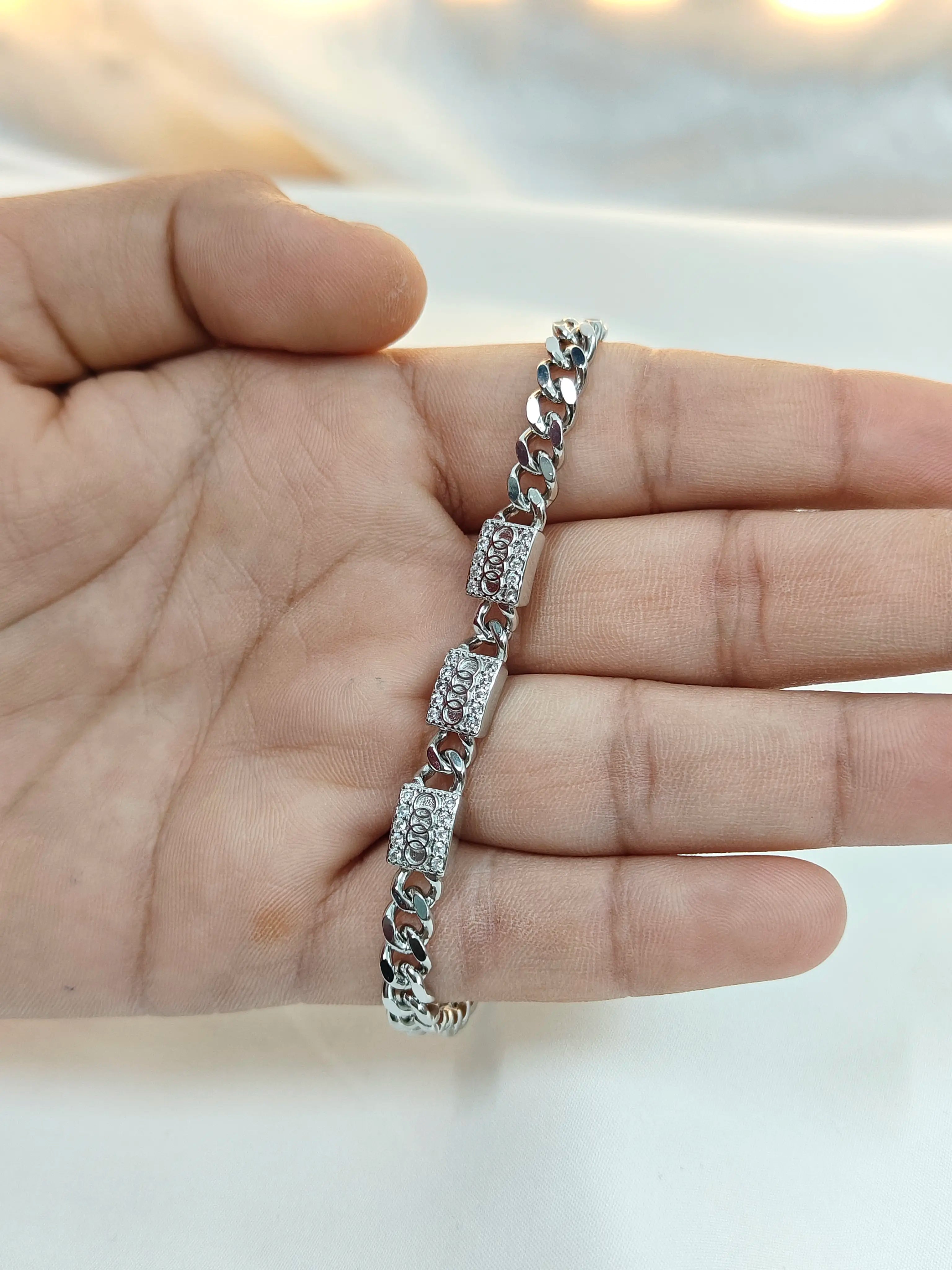 Silver bracelet on a hand with a blurred background