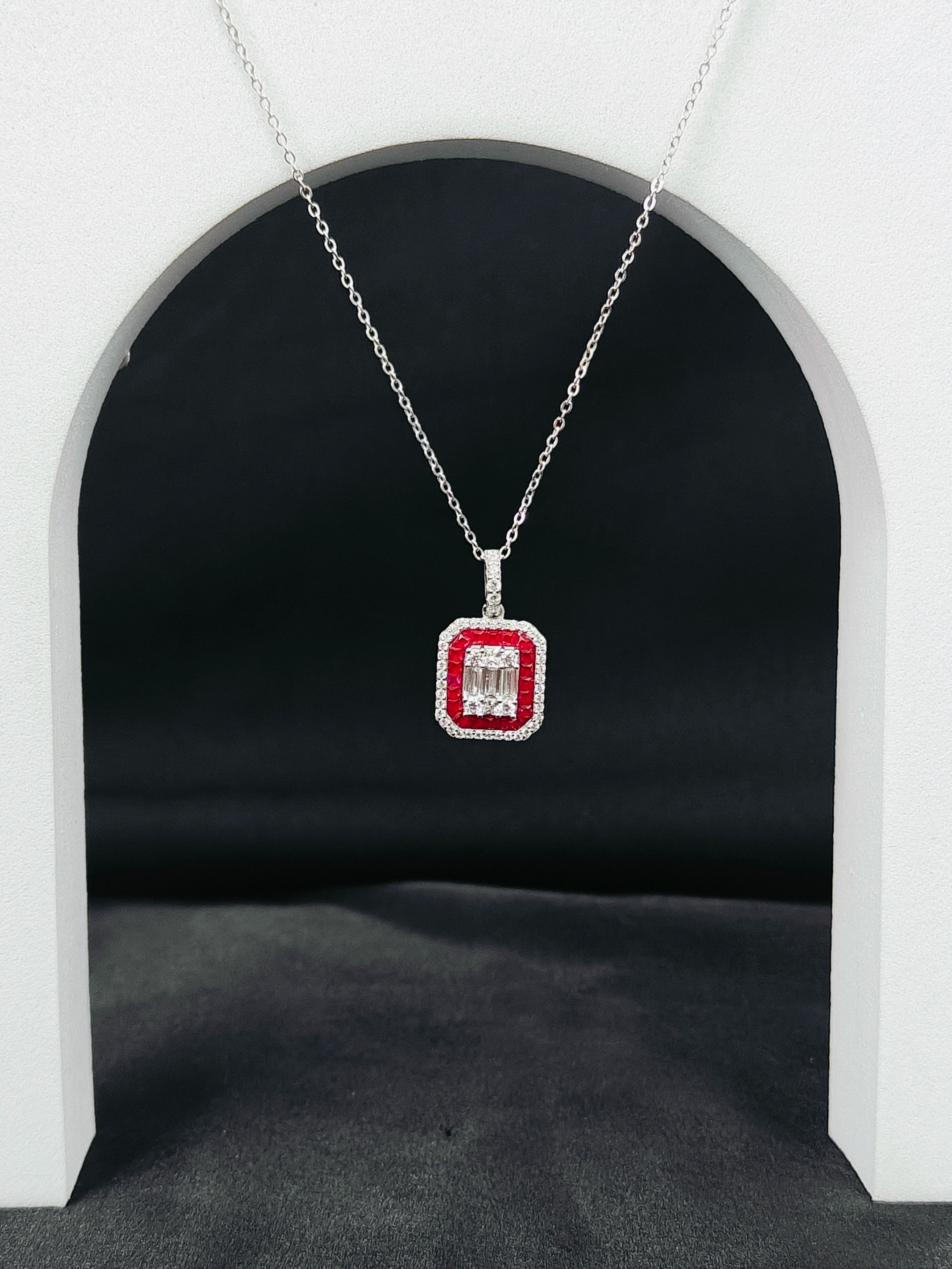 Diamond necklace with a red gemstone pendant on a dark background