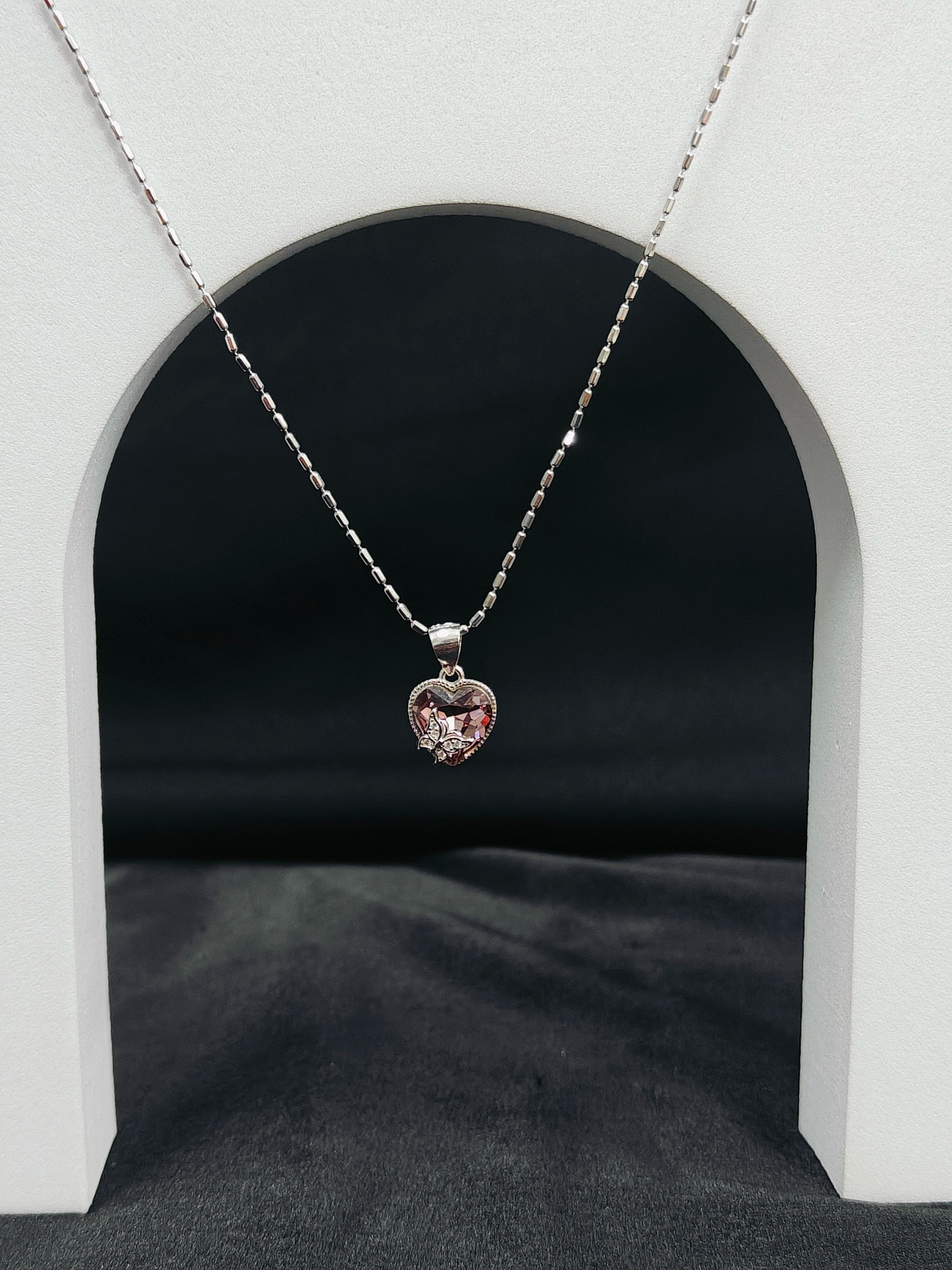 Necklace with a heart-shaped pendant on a dark background